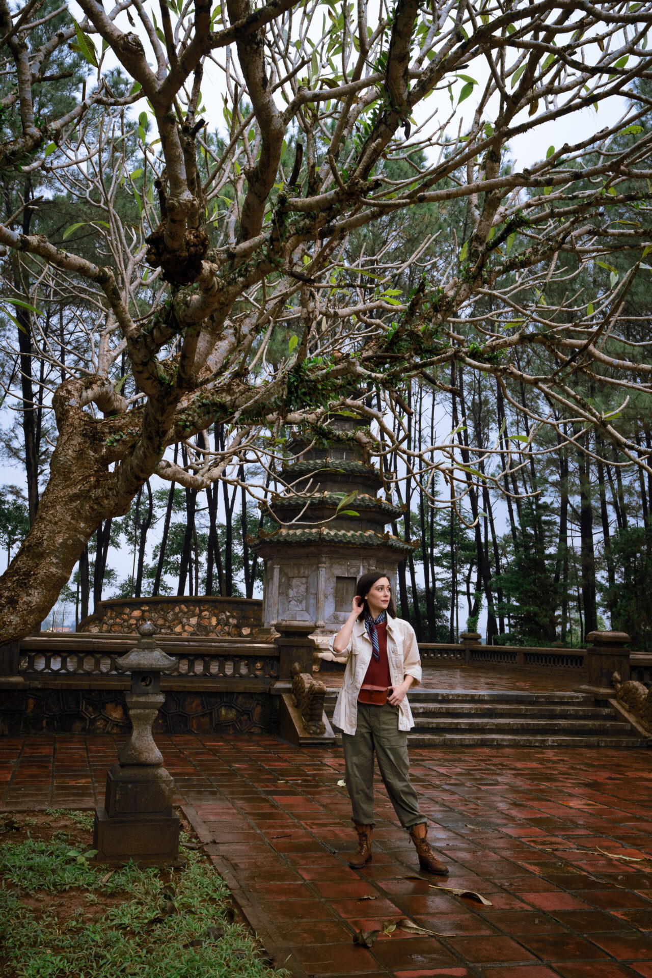 Travel Blogger Jordan Gassner looking off into the distance near the back gardens at Thien Mu Pagoda in Hue, Vietnam