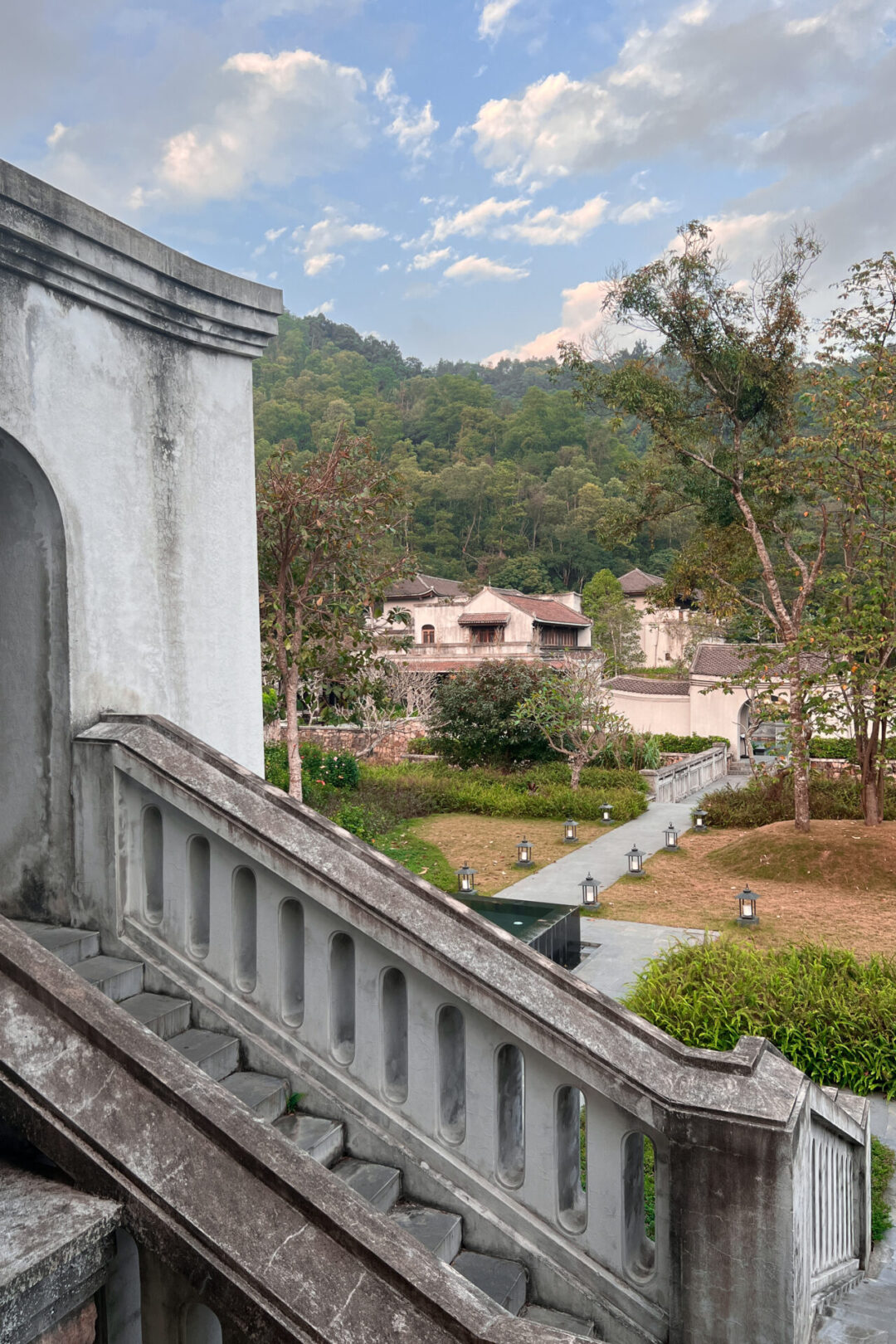 A staircase leading to a lantern lit pathway to the pool at Legacy Yen Tu Resort in Vietnam