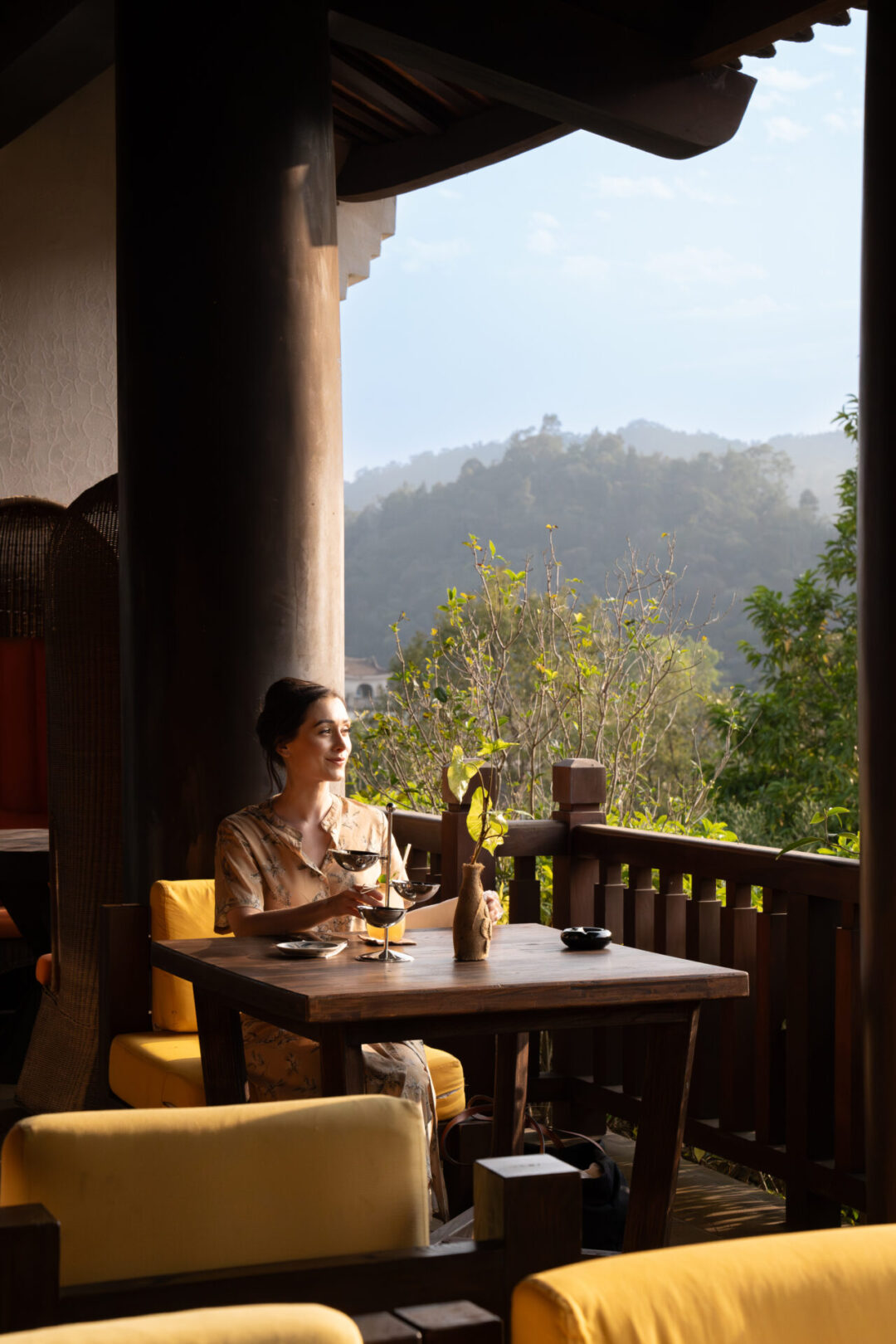 Travel Blogger Jordan Gassner sitting at a balcony adjacent table inside Thien Quan restaurant in Legacy Yen Tu Resort in Vietnam