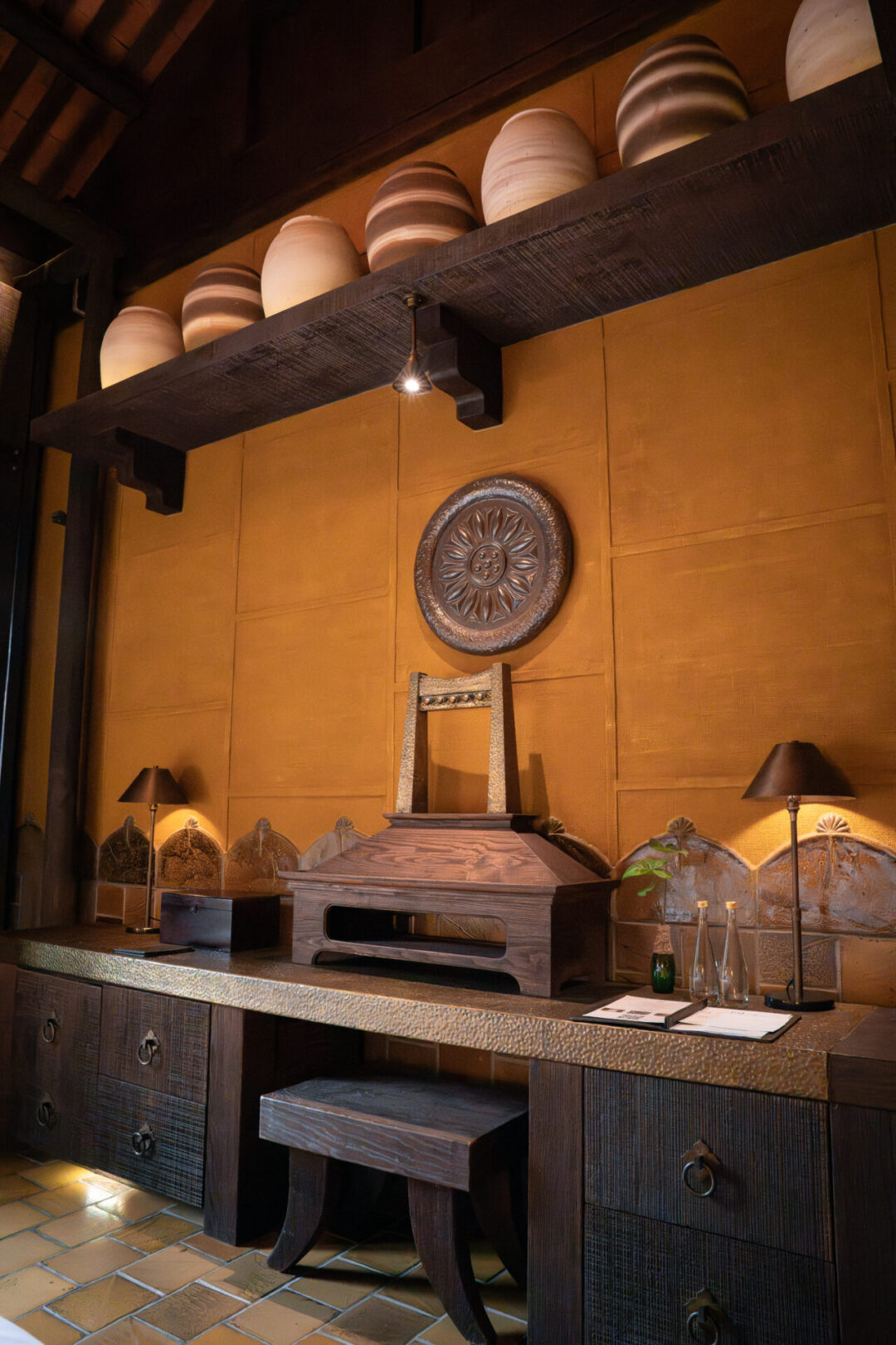 The long desk table inside the bedroom of one of the Deluxe Room with a Pool View at Legacy Yen Tu in Vietnam