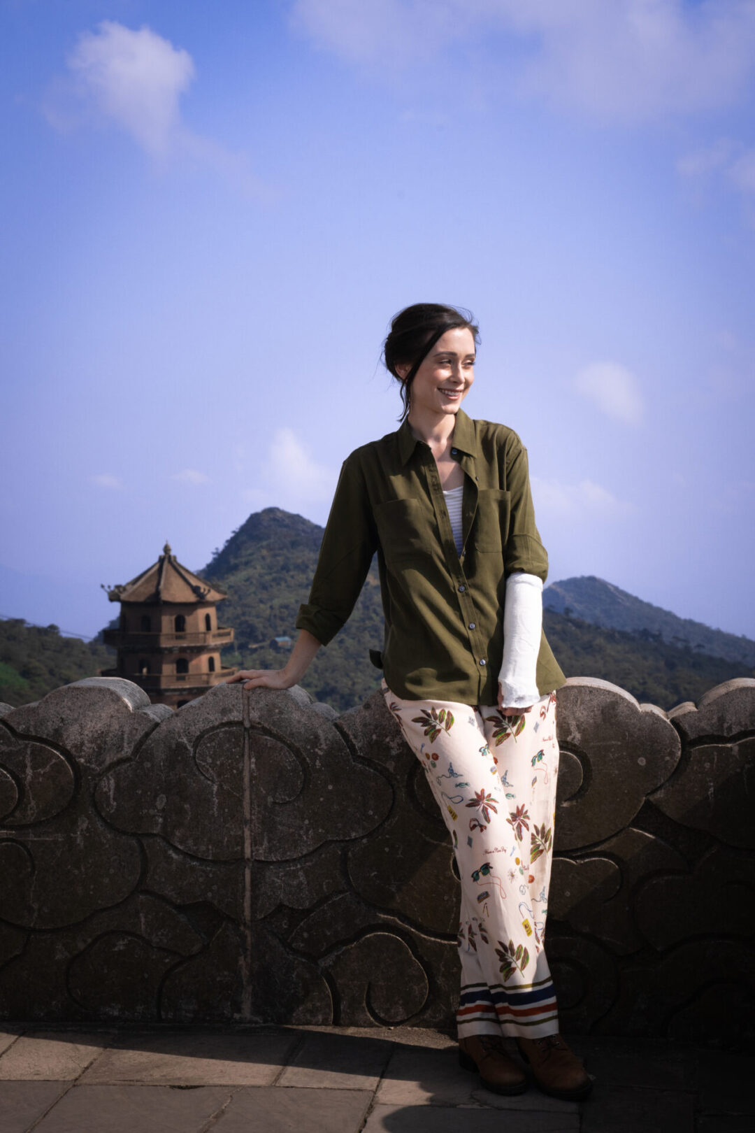 Travel Blogger Jordan Gassner leaning against a cloud-etched wall on top of Yen Tu Mountain in Northern Vietnam