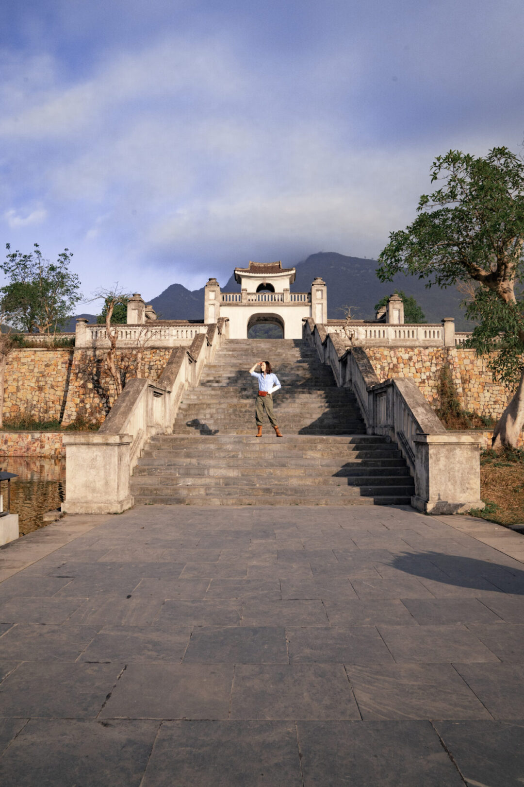 Travel Blogger Jordan Gassner standing on a grand staircase in Yen Tu Village in Vietnam