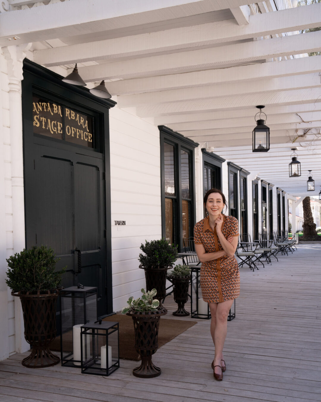 Travel Blogger Jordan Gassner laughing near the entrance to Mattei's Tavern in Los Olivos, California