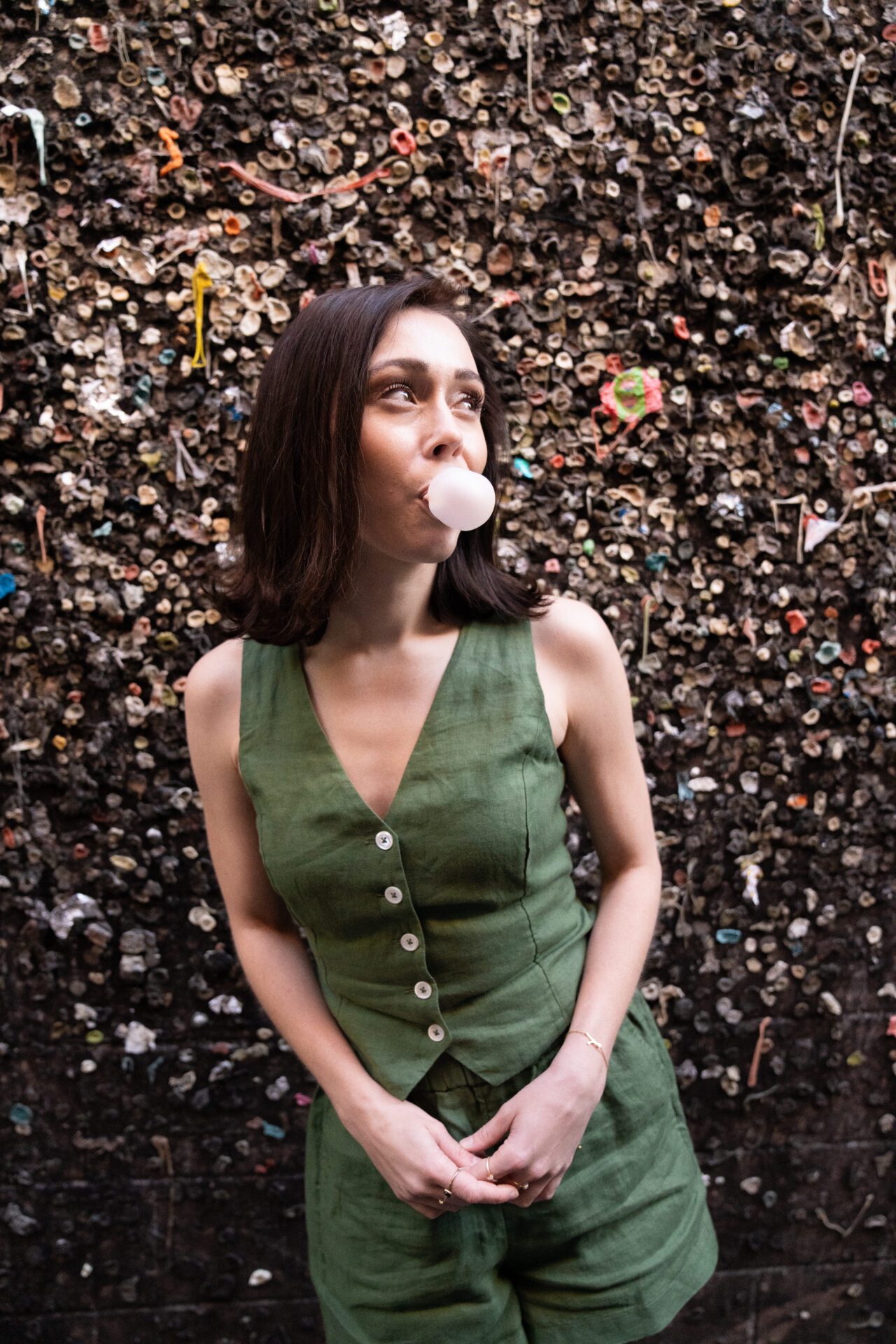 Travel Blogger Jordan Gassner blowing a bubble at Bubble Gum Alley in San Luis Obispo, California