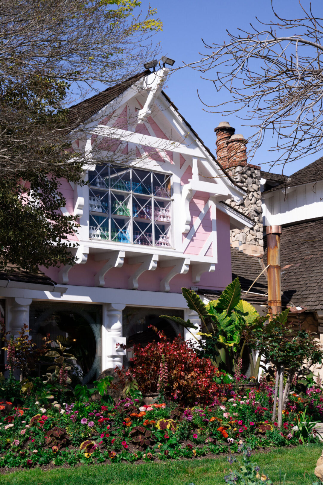 A rainbow of clear glasses lining the window inside the pink Madonna Inn in San Luis Obispo, California
