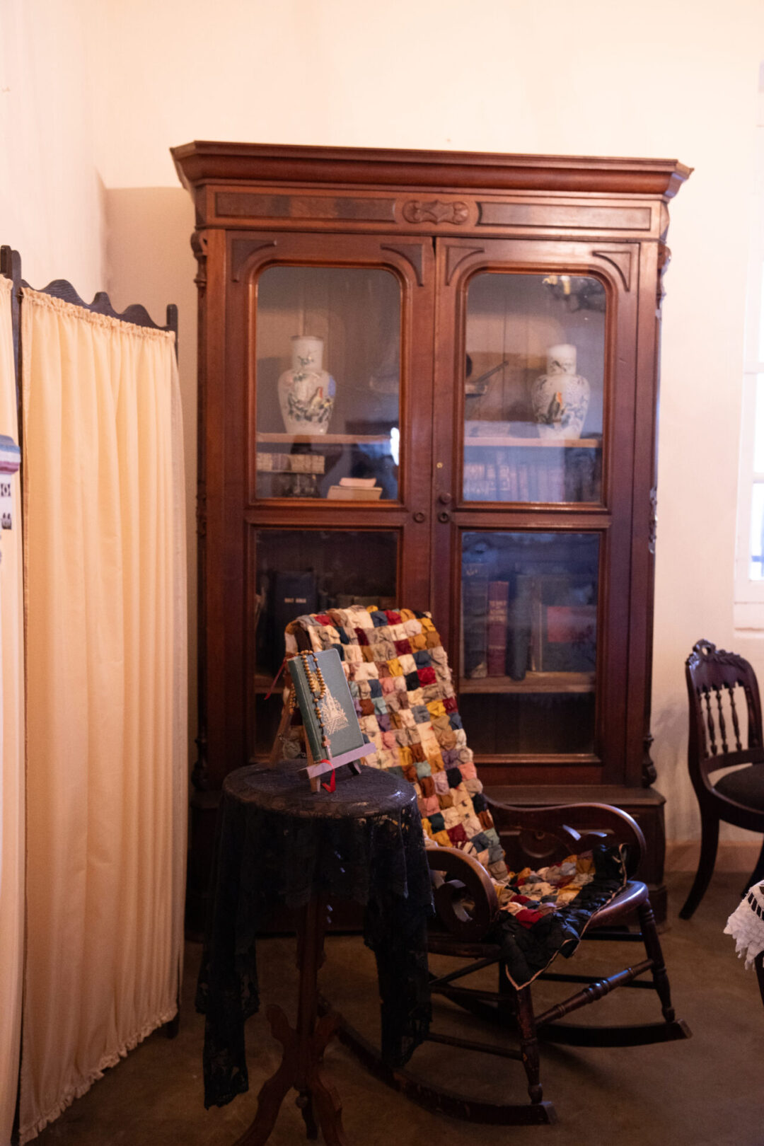 An old rocking chair and colorful quilt inside Mission San Luis Obispo De Tolosa in Central California