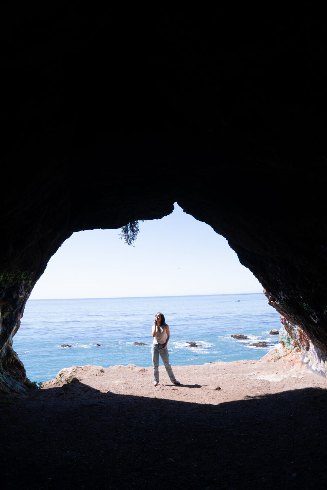Travel Blogger Jordan Gassner standing at the exit of the Pirate's Cove Cave in San Luis Obispo along the California Coast