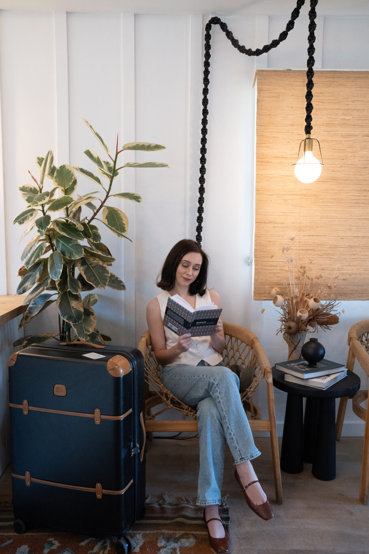 Travel Blogger Jordan Gassner reading a book in the lobby of San Luis Creek Lodge in San Luis Obispo, California