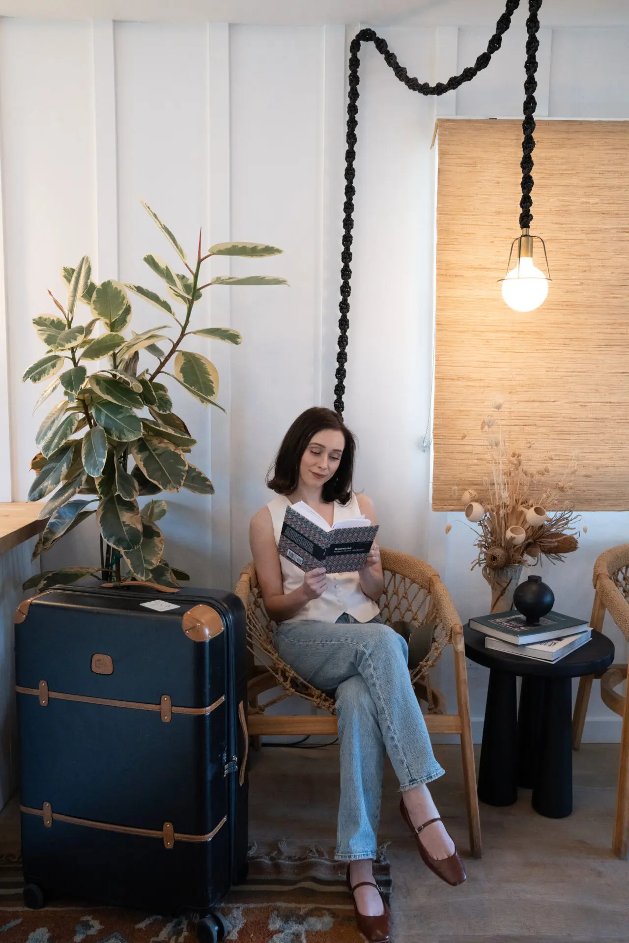 Travel Blogger Jordan Gassner reading a book in the lobby of San Luis Creek Lodge in San Luis Obispo, California
