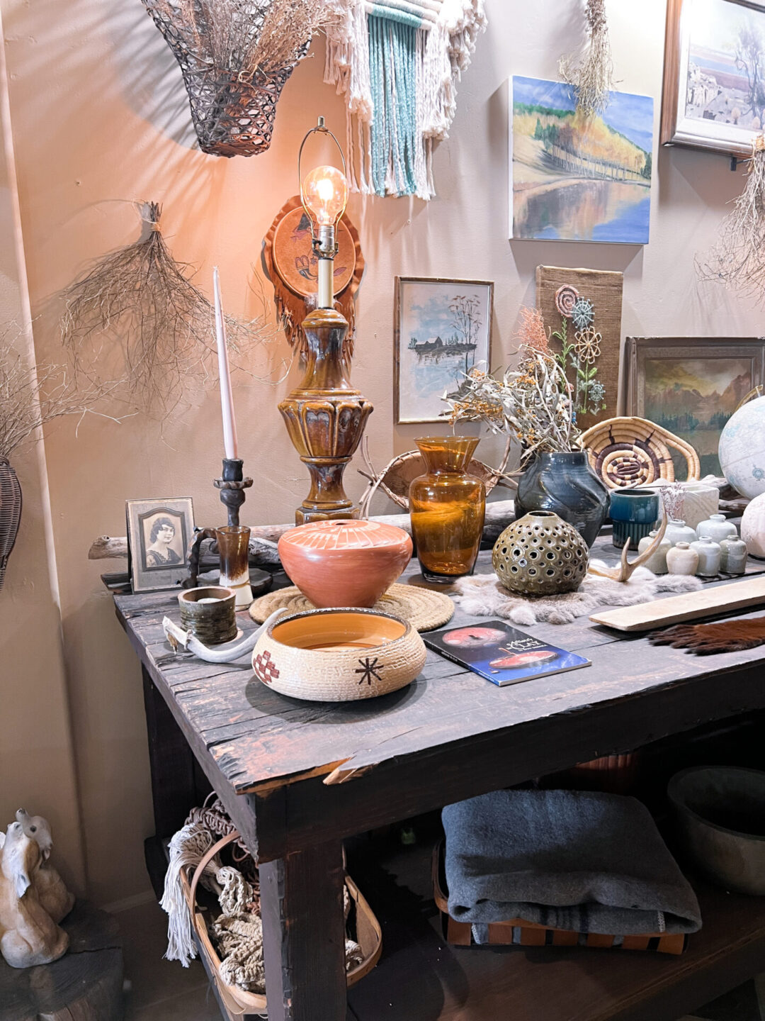 A table full of decorative home decor pieces inside The Hangout, a vintage clothing store in Downtown San Luis Obispo, California