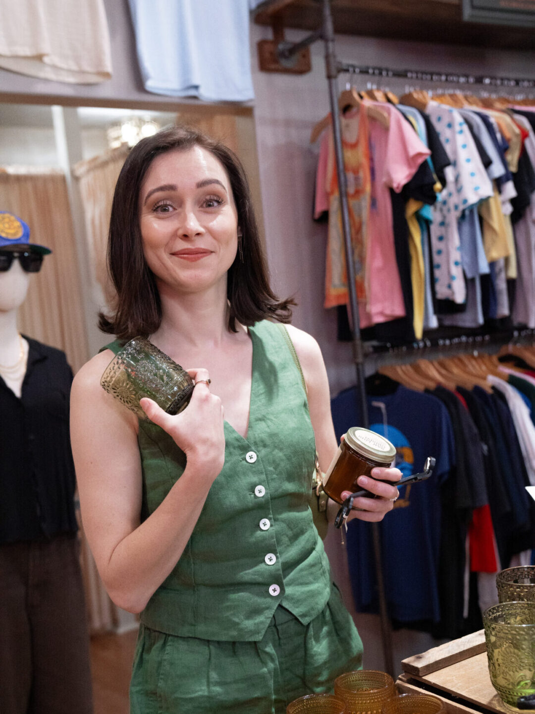 Travel Blogger Jordan Gassner holding a candle and a new set of glasses inside Blackwater Boutique in San Luis Obispo, California
