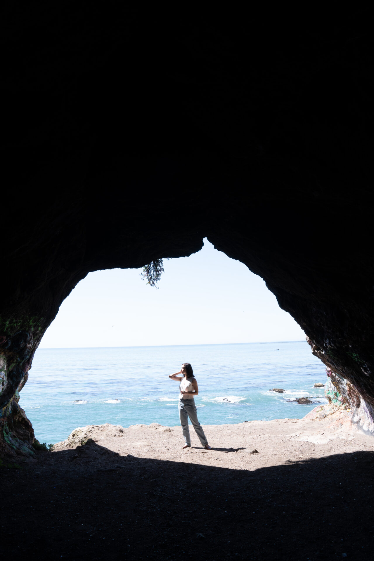Travel Blogger Jordan Gassner looking out at the ocean from the Pirate's Cove Cave in San Luis Obispo along the California Coast