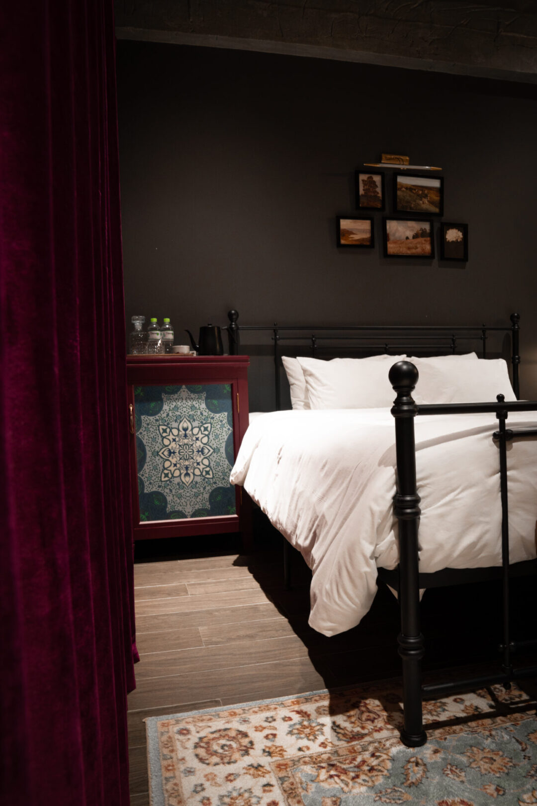 The plush bed, bar area and carpeted area inside one of the rooms at the Chum Boutique Hotel in Hue, Vietnam