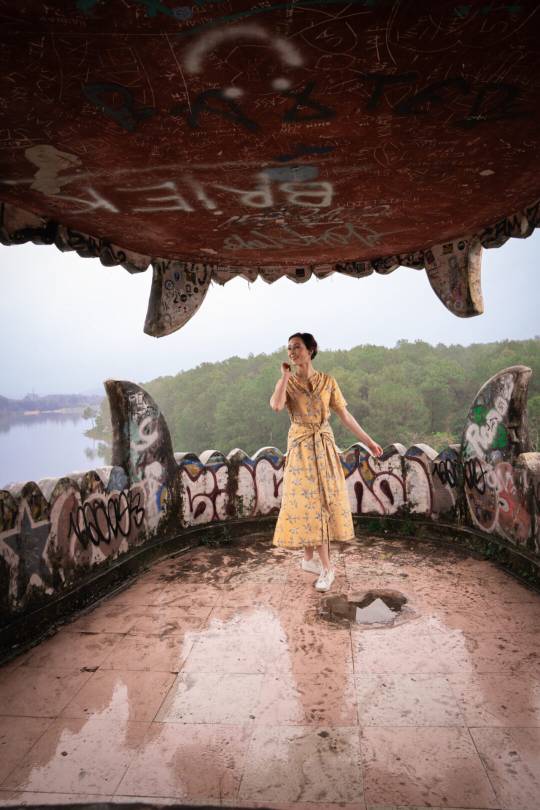 Travel Blogger Jordan Gassner smiling inside the mouth of the dragon structure in Hue, Vietnam