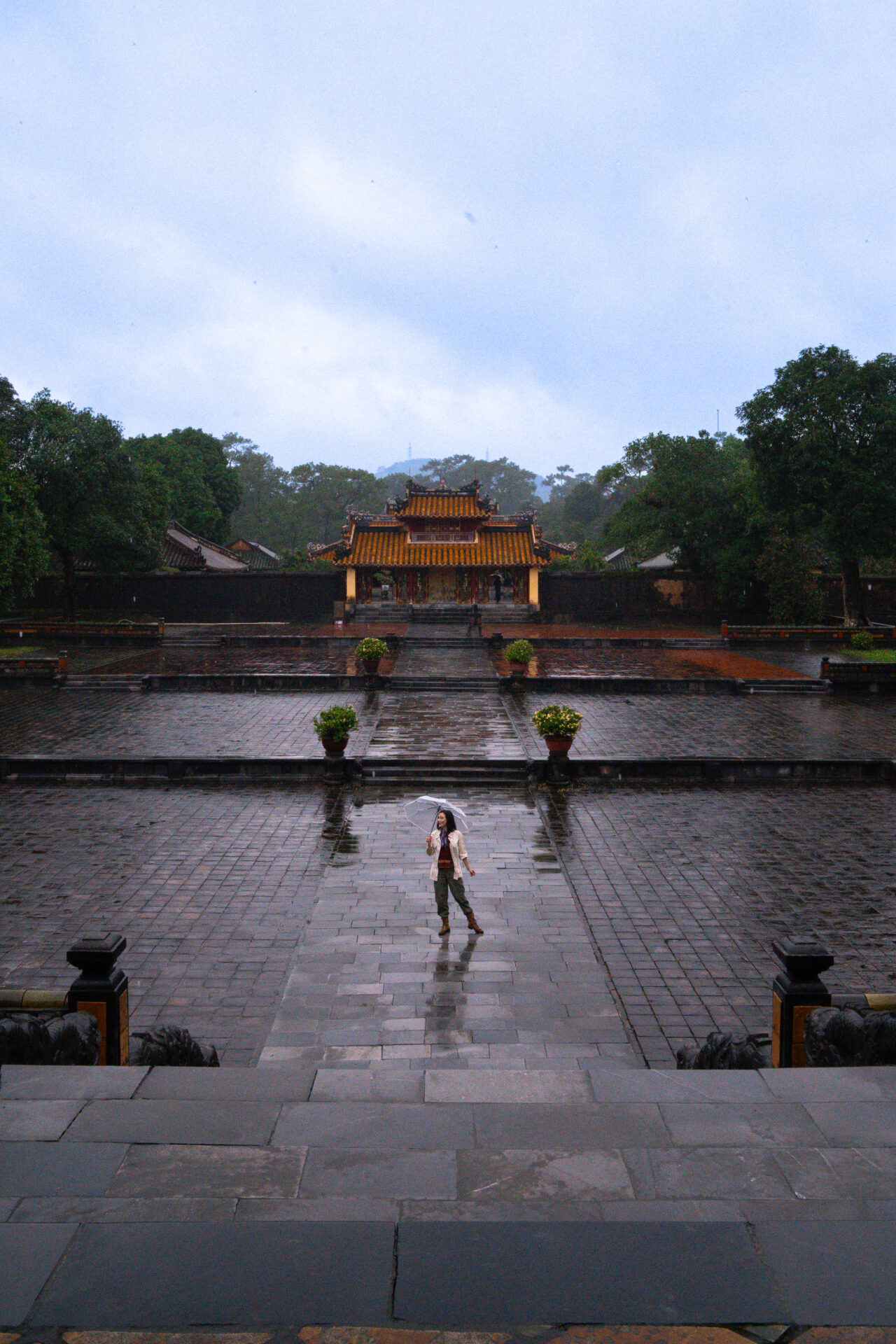 Travel Blogger Jordan Gassner walking along the pathway of an empty Tomb of Minh Mang in Hue, Vietnam