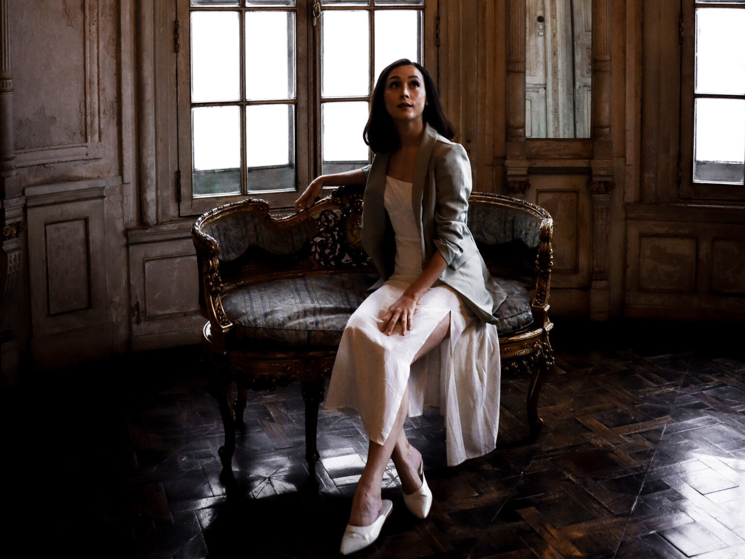 Travel Blogger Jordan Gassner sitting on a chaise lounge inside Casa Fernandini, one of many historic homes in Lima, Peru