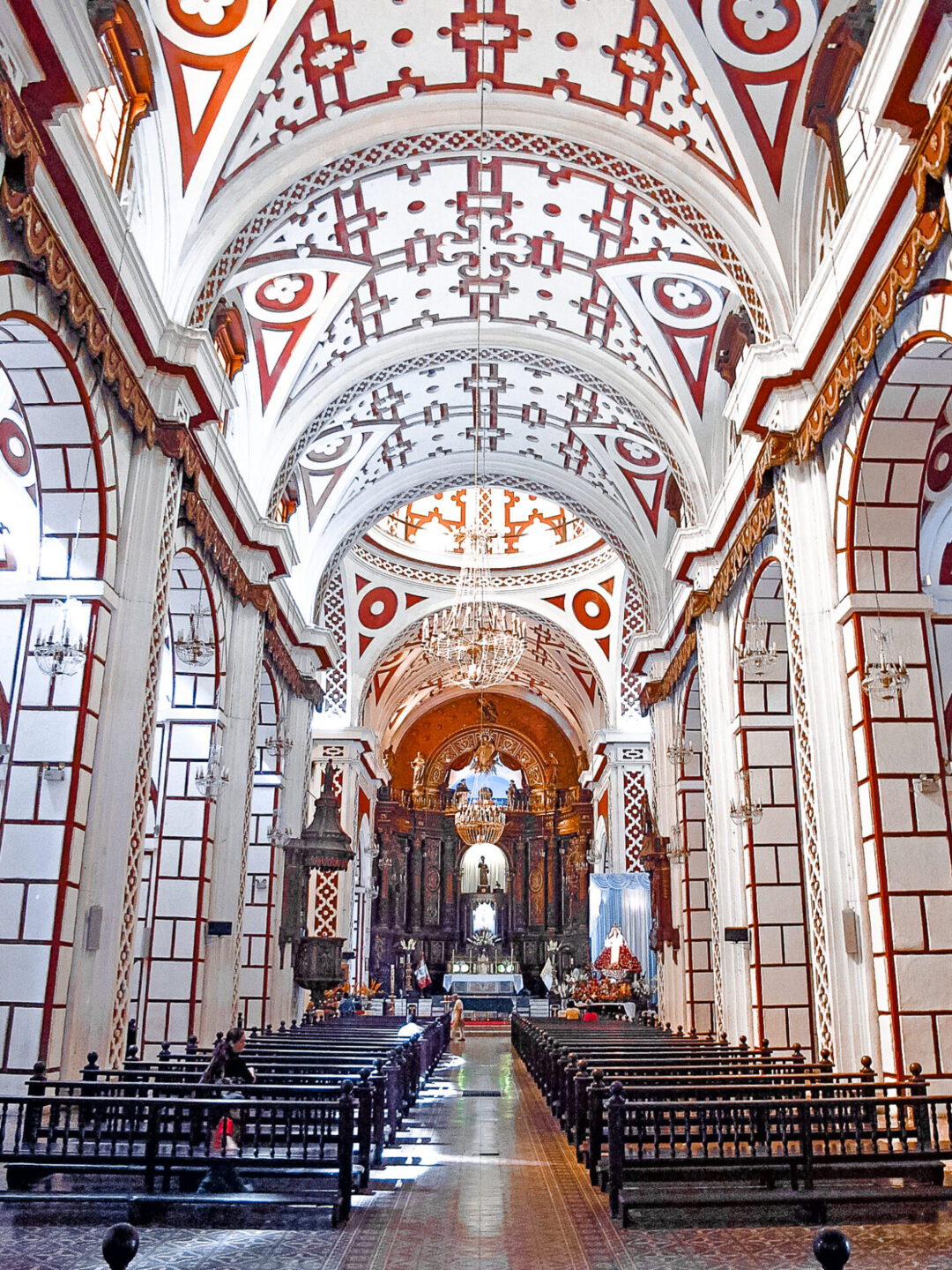 The red and white interior of Iglesia de San Francisco in Lima, Peru