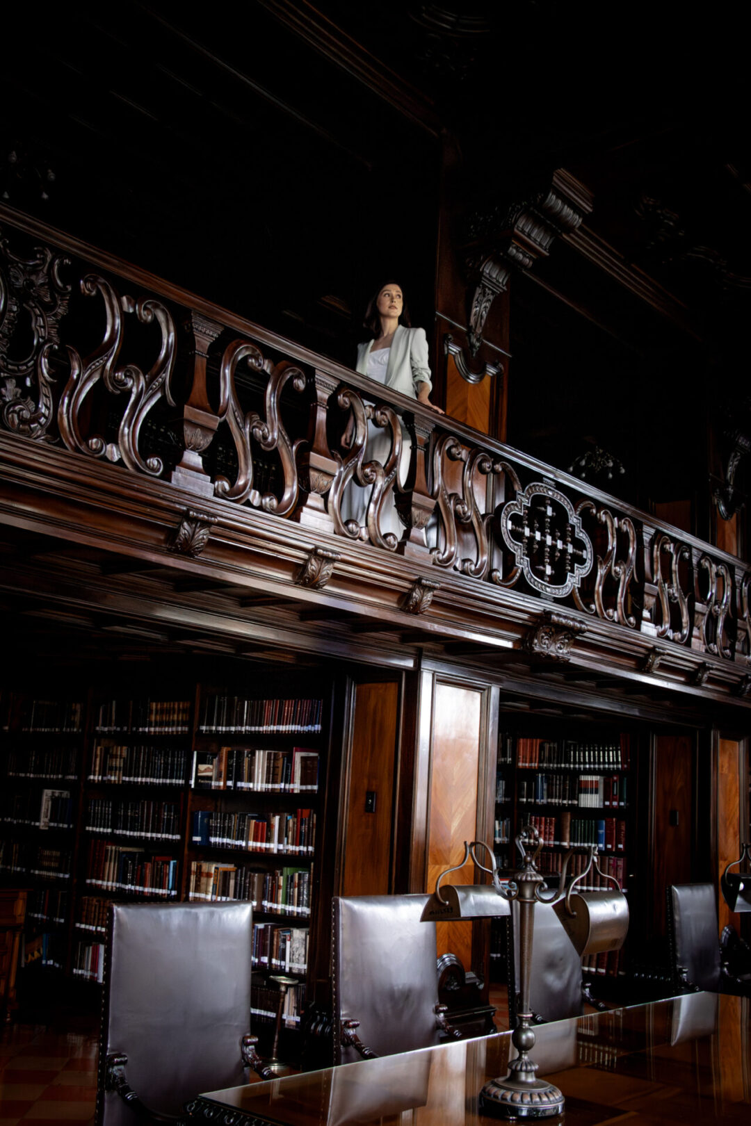 Travel Blogger Jordan Gassner walking along the second floor balcony inside the Municipal Palace Library in Lima, Peru
