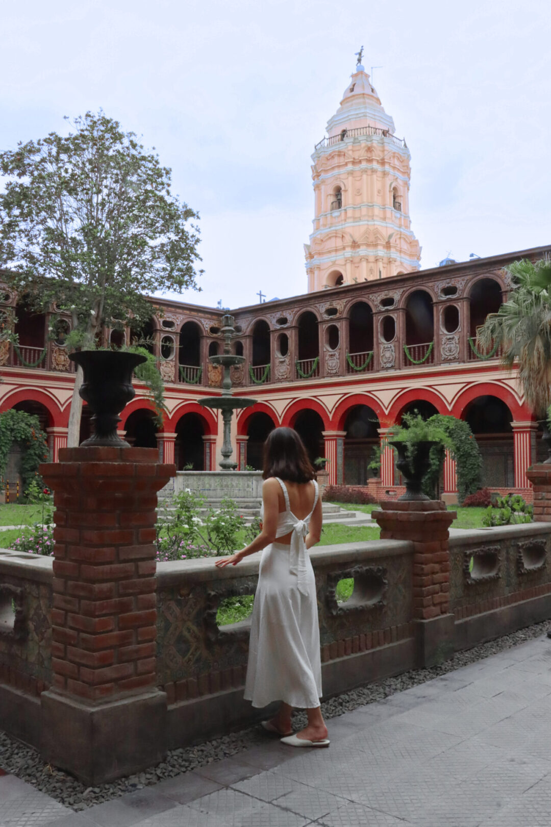 Travel Blogger Jordan Gassner looking out into the courtyard of Santo Domingo Convent in Lima, Peru