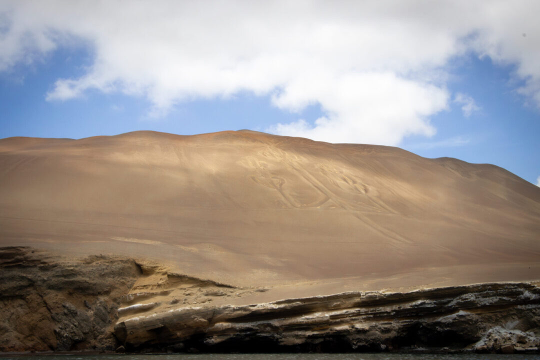 The Paracas Candelabra seen on a sandy hillside from the Pacific Ocean in Peru