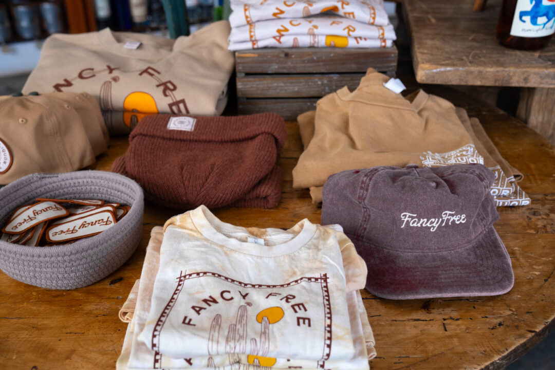 A table of merchandise inside Fancy Free Liquor, a natural wine and modern liquor shop in Los Angeles California