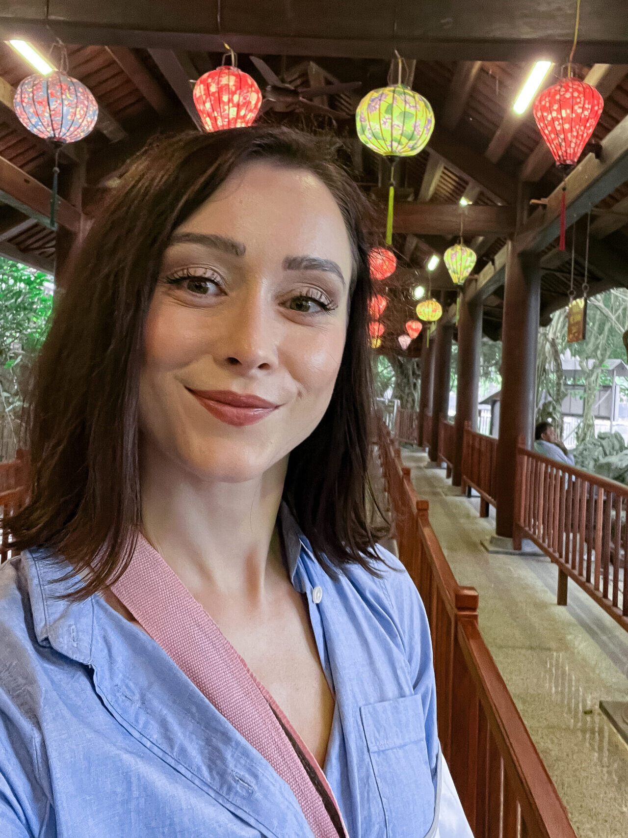 Travel Blogger Jordan Gassner standing in a lantern-strewn line leading up to the Trang An Boat Departure Area in Ninh Binh, Vietnam