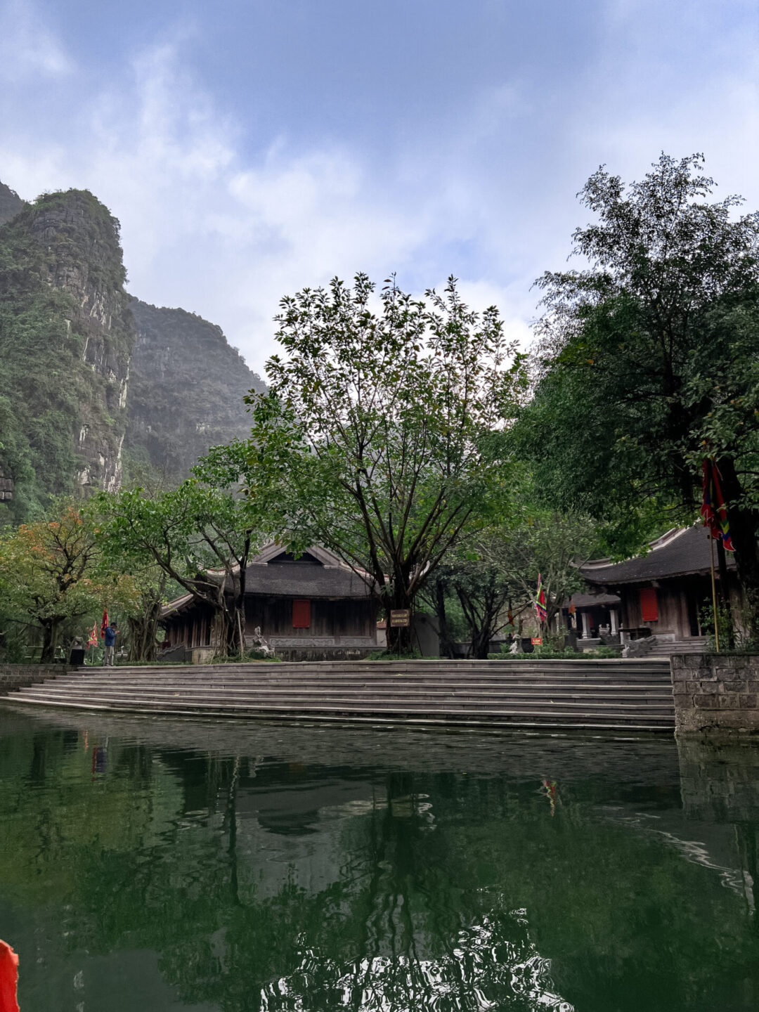 Vu Lam Palace as seen from a Trang An traditional sampan boat in Ninh Binh, Vietnam