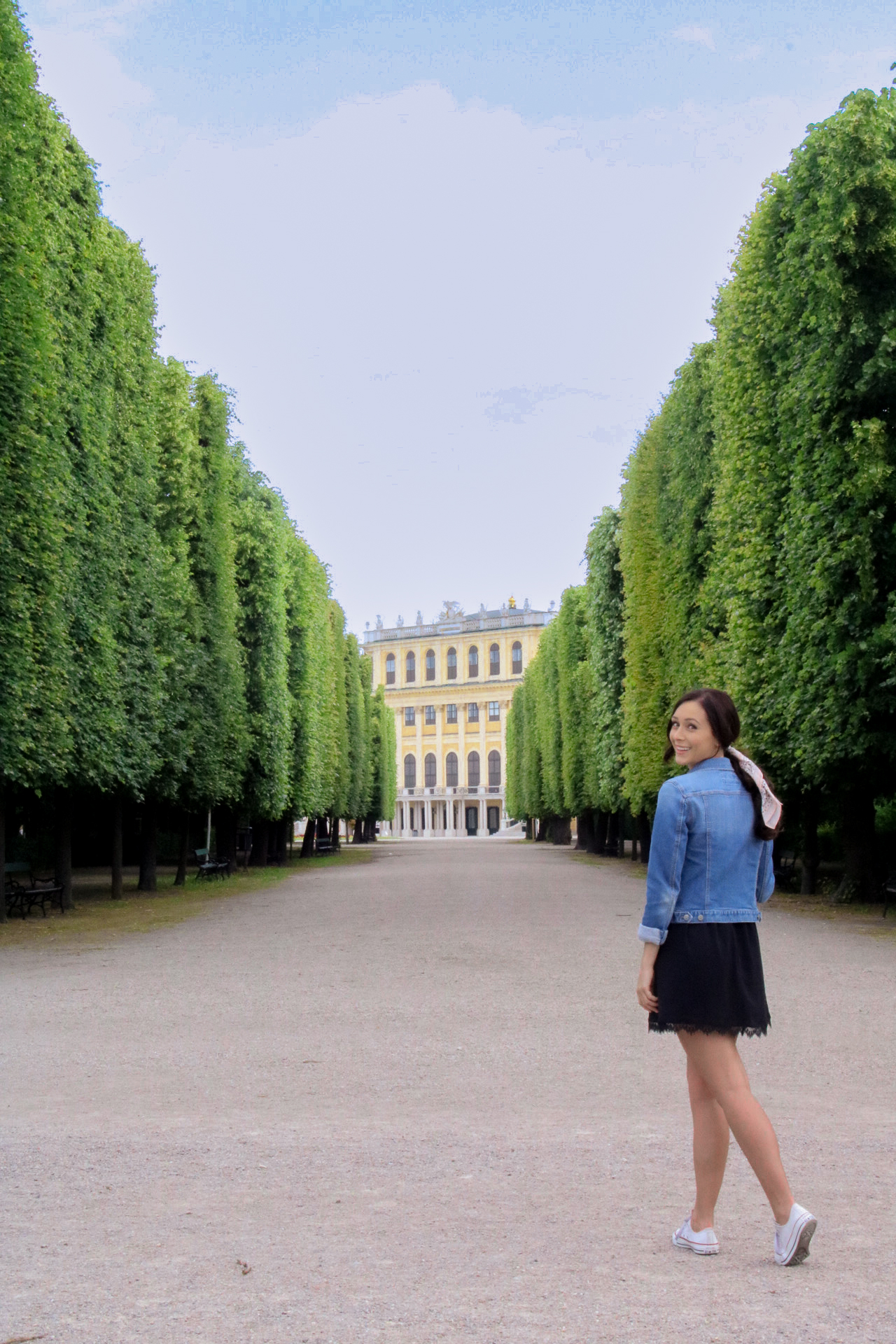 Travel Blogger Jordan Gassner standing in the gardens of Schönbrunn in Vienna, Austria