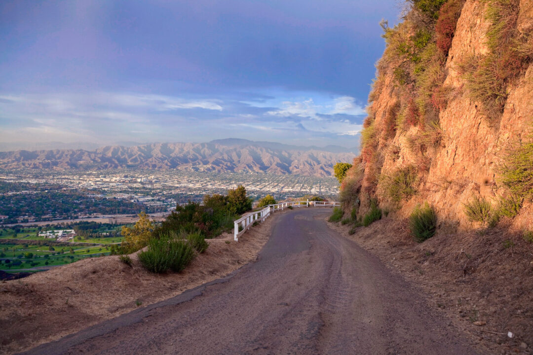 Griffith Park Road with thunder clouds and afternoon light. High in the hills above Los Angeles Burbank and Glendale, California.