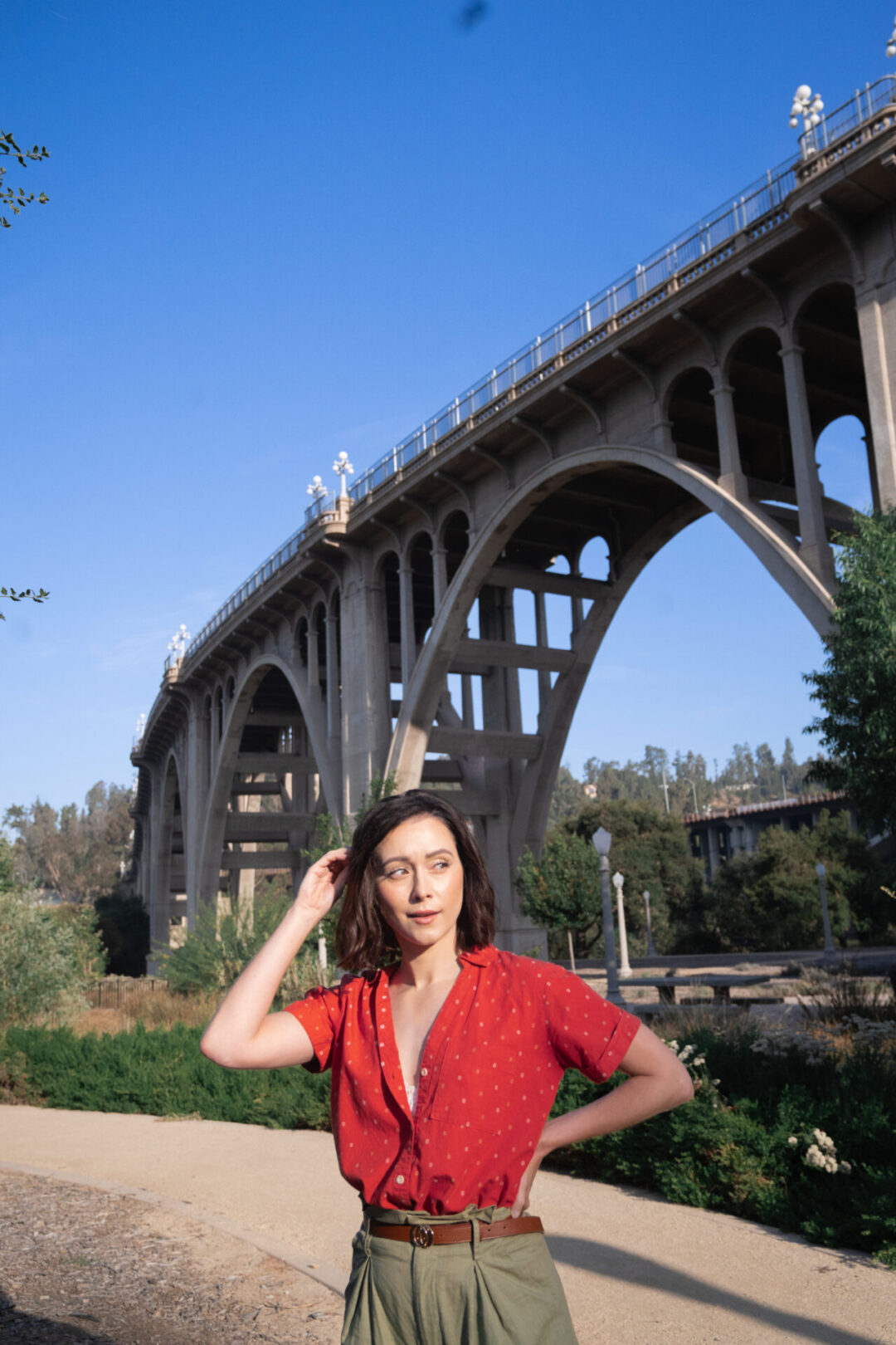 Travel Blogger Jordan Gassner standing below Colorado Street Bridge one of the La La Land filming locations in Pasadena, Caliofrnia