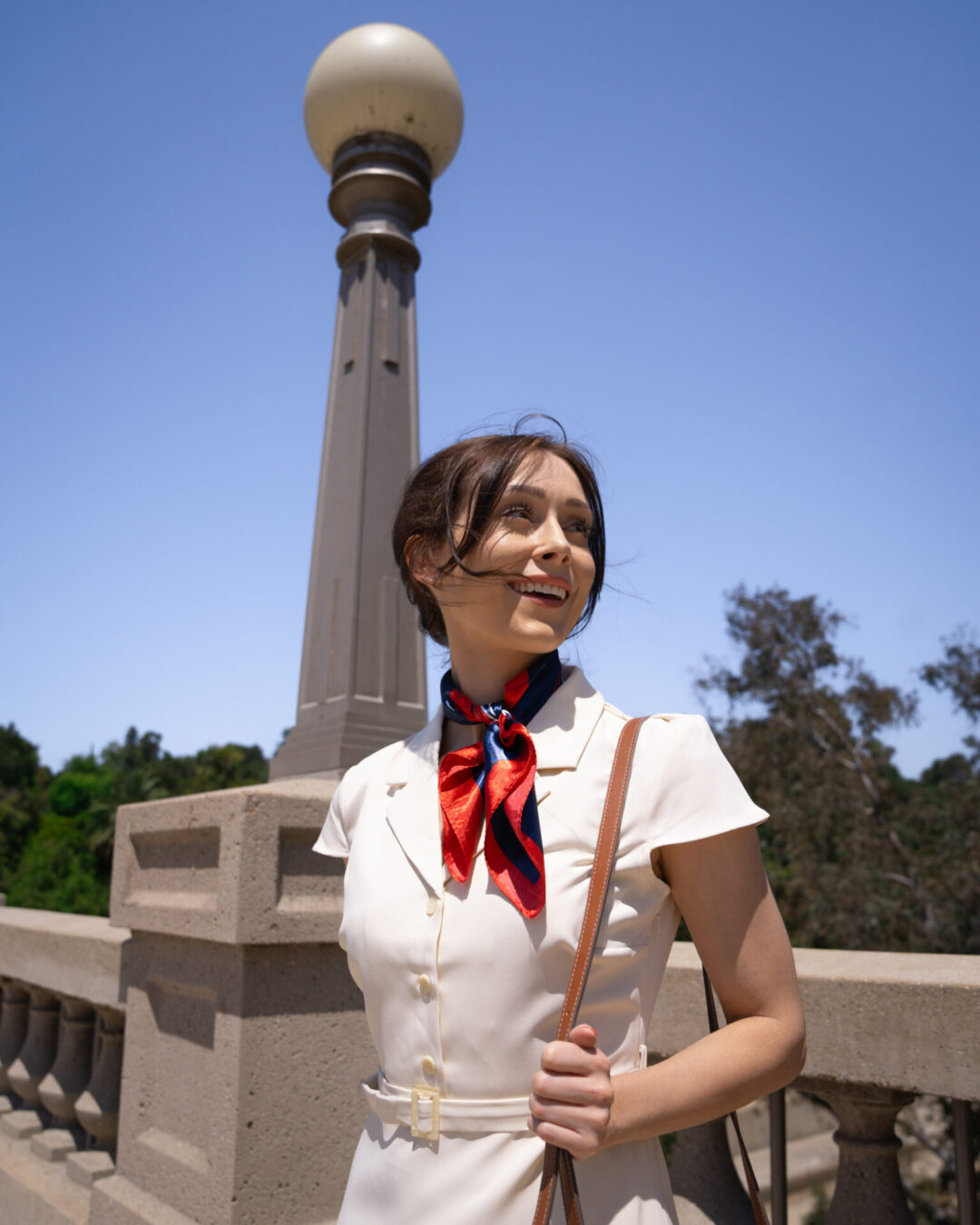 Travel Blogger Jordan Gassner smiling with windswept hair along the La Loma Bridge in Pasadena, California