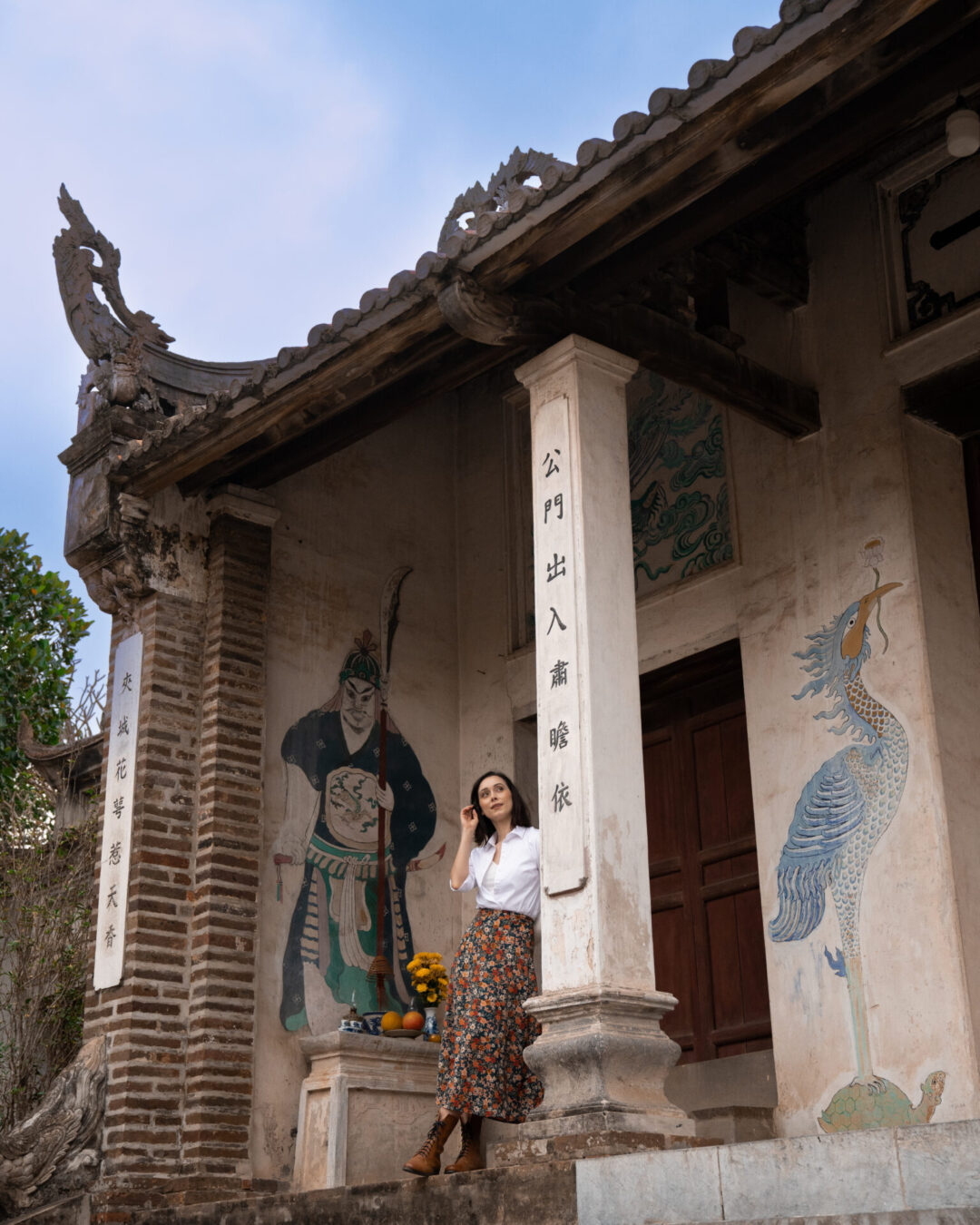 Travel Blogger Jordan Gassner leaning against a pillar inside one of the pagodas in Co Loa Citadel, near Hanoi, Vietnam