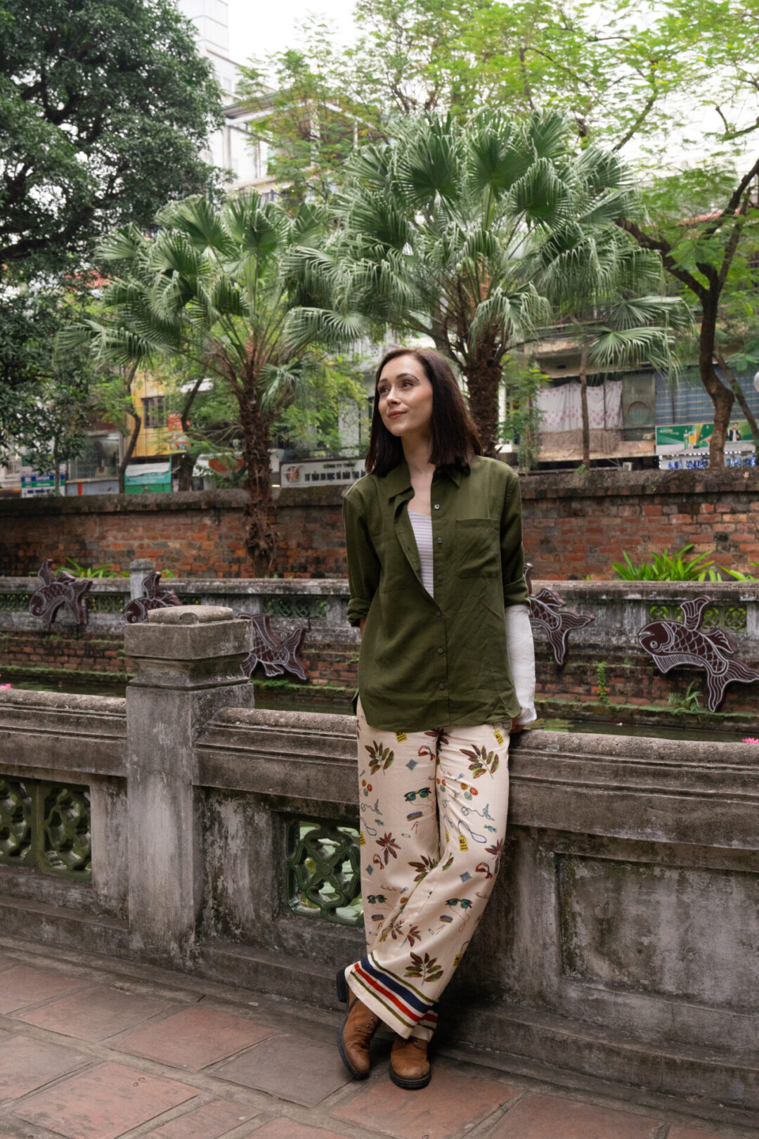 Travel Blogger Jordan Gassner leaning against a railing inside the Temple of Literature in Hanoi, Vietnam