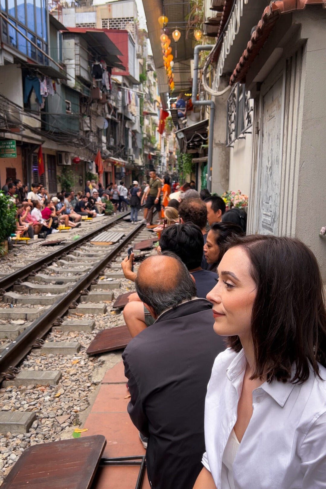 Travel Blogger Jordan Gassner looking out toward the tracks on Hanoi's Instagram-famous Train Street