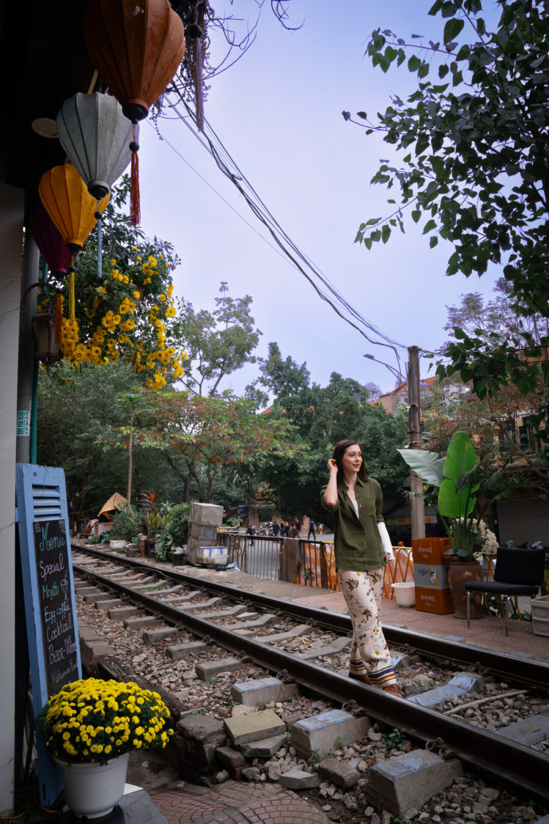 Mistakes I Made In Vietnam: Travel Blogger Jordan Gassner standing on the train tracks neat Phung Hung Street in Hanoi, Vietnam
