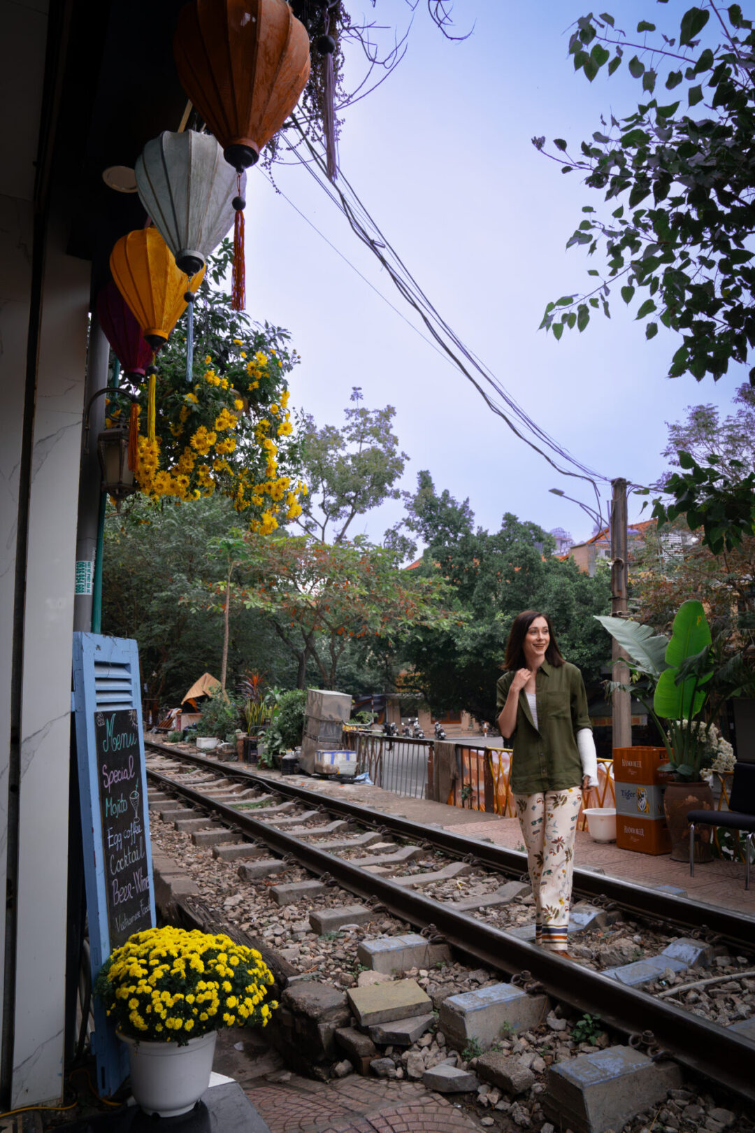 Travel Blogger Jordan Gassner smiling while walking along Train Street near Phung Hung Street in Hanoi, Vietnam