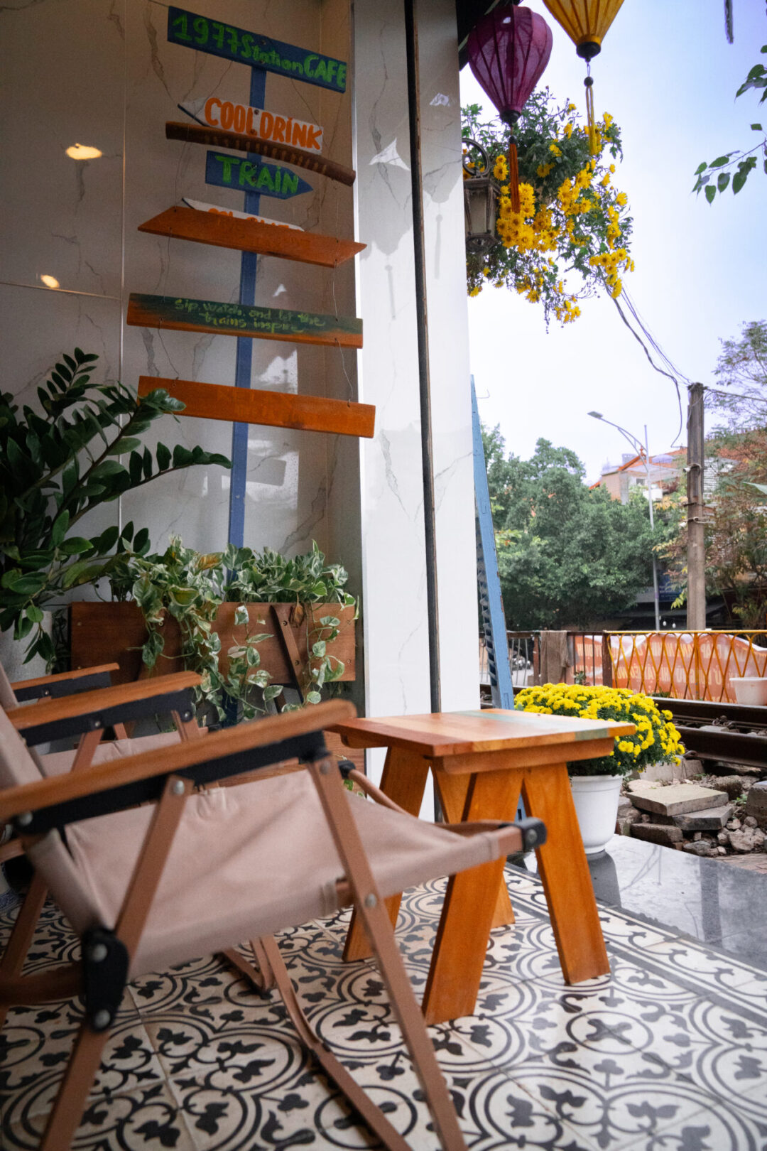 A lounge chair and small table inside of a cafe along Train Street in Hanoi, Vietnam