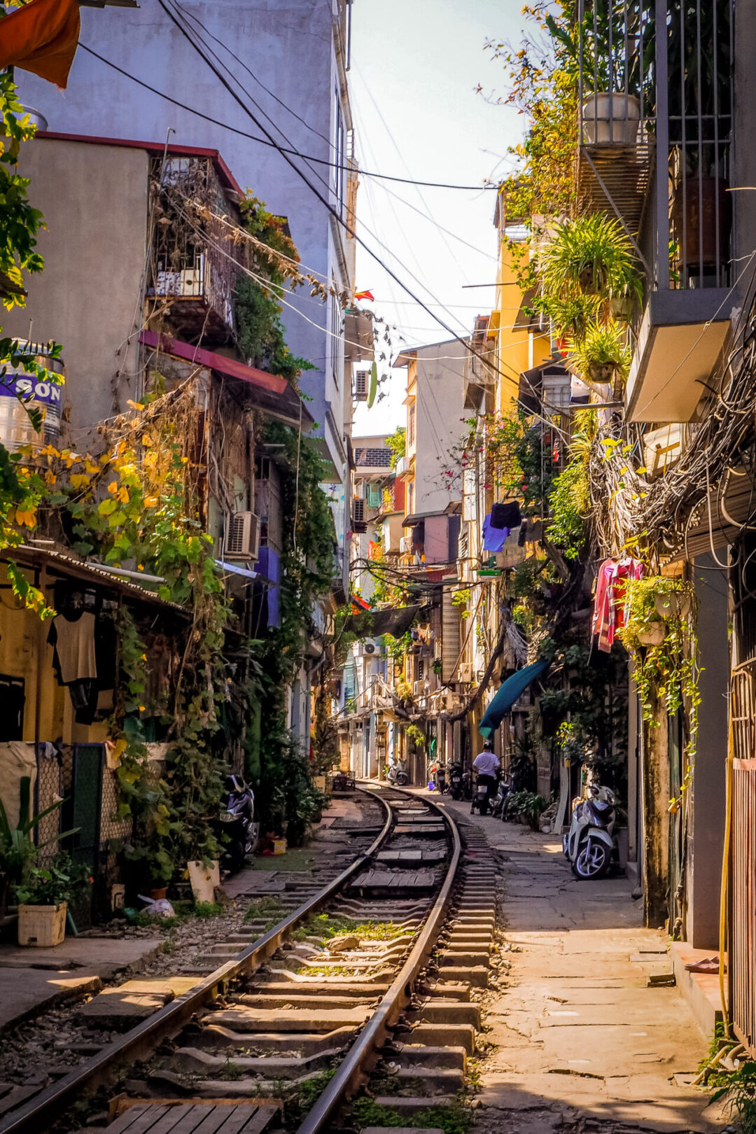 The warm glow of the sun hitting the train tracks on a residential section of Train Street in Hanoi, Vietnam