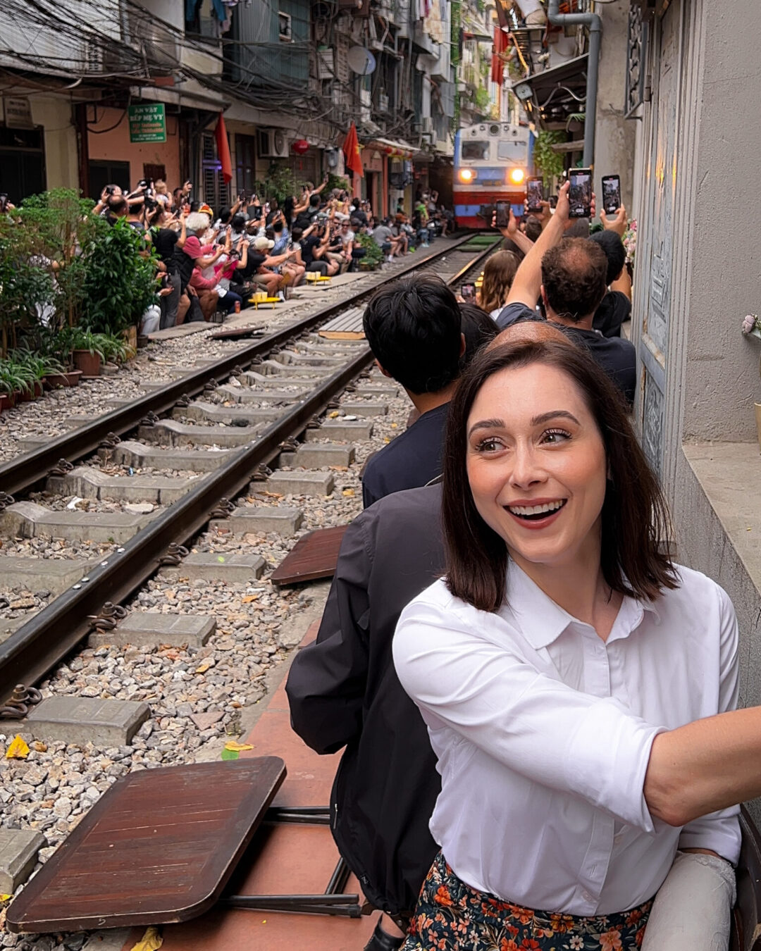 Travel Blogger Jordan Gassner standing on the train tracks neat Phung Hung Street in Hanoi, Vietnam