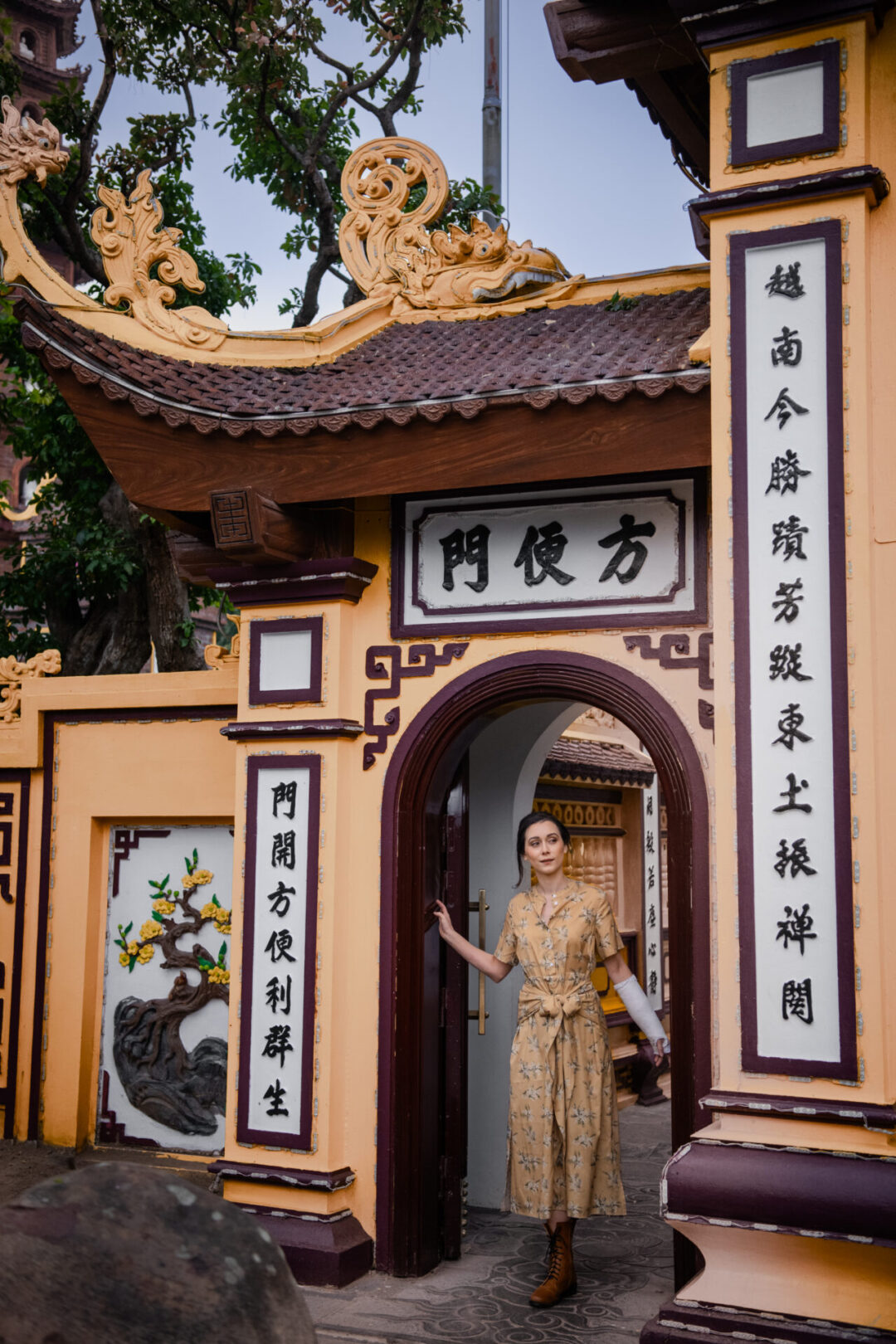 Travel Blogger Jordan Gassner passing underneath an archway at Tran Quoc Pagoda in Hanoi, Vietnam