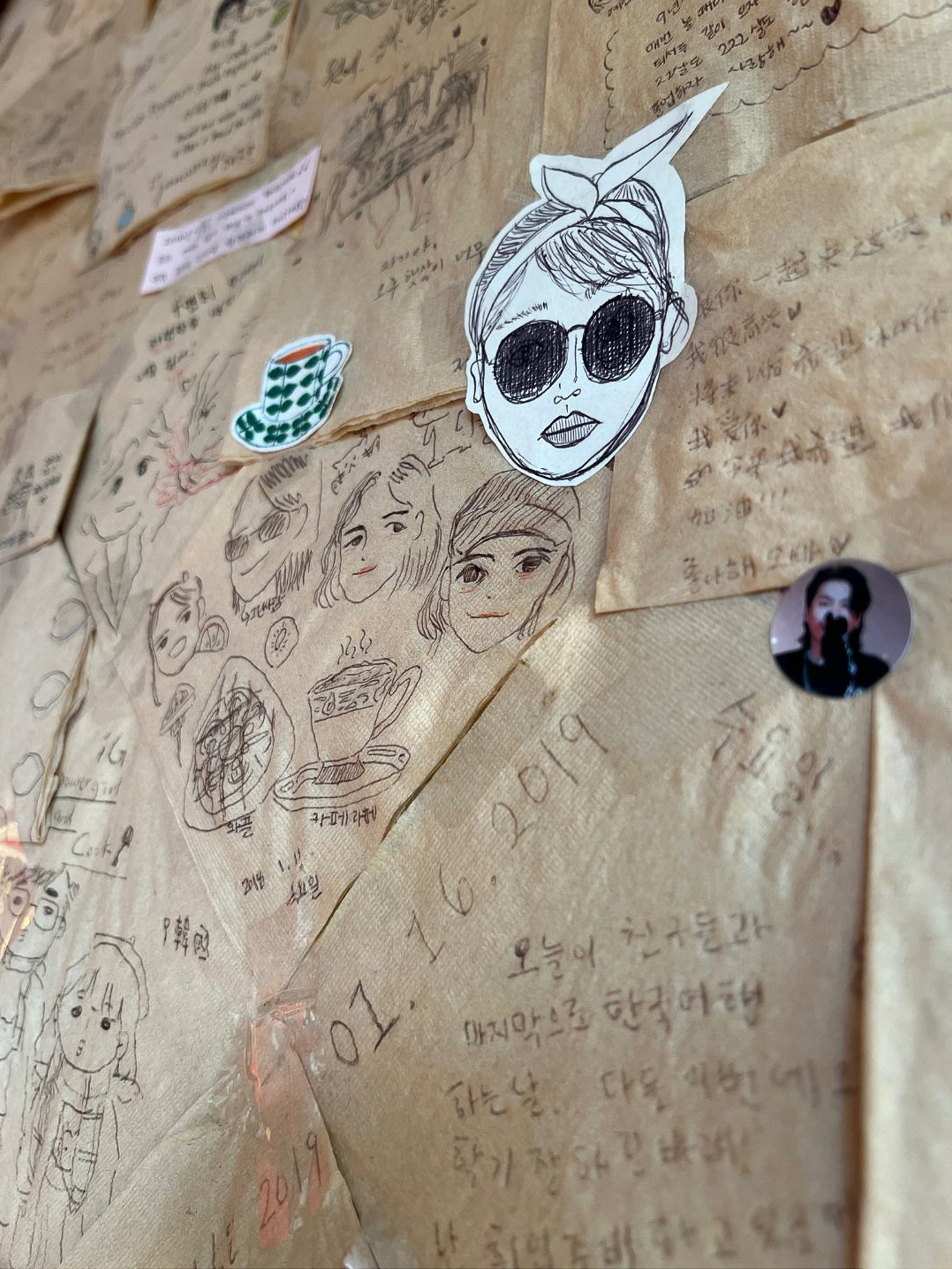 A few handwritten notes and doodles hanging along the famous napkin wall inside Whitebirch Story Tea House in Seoul, South Korea