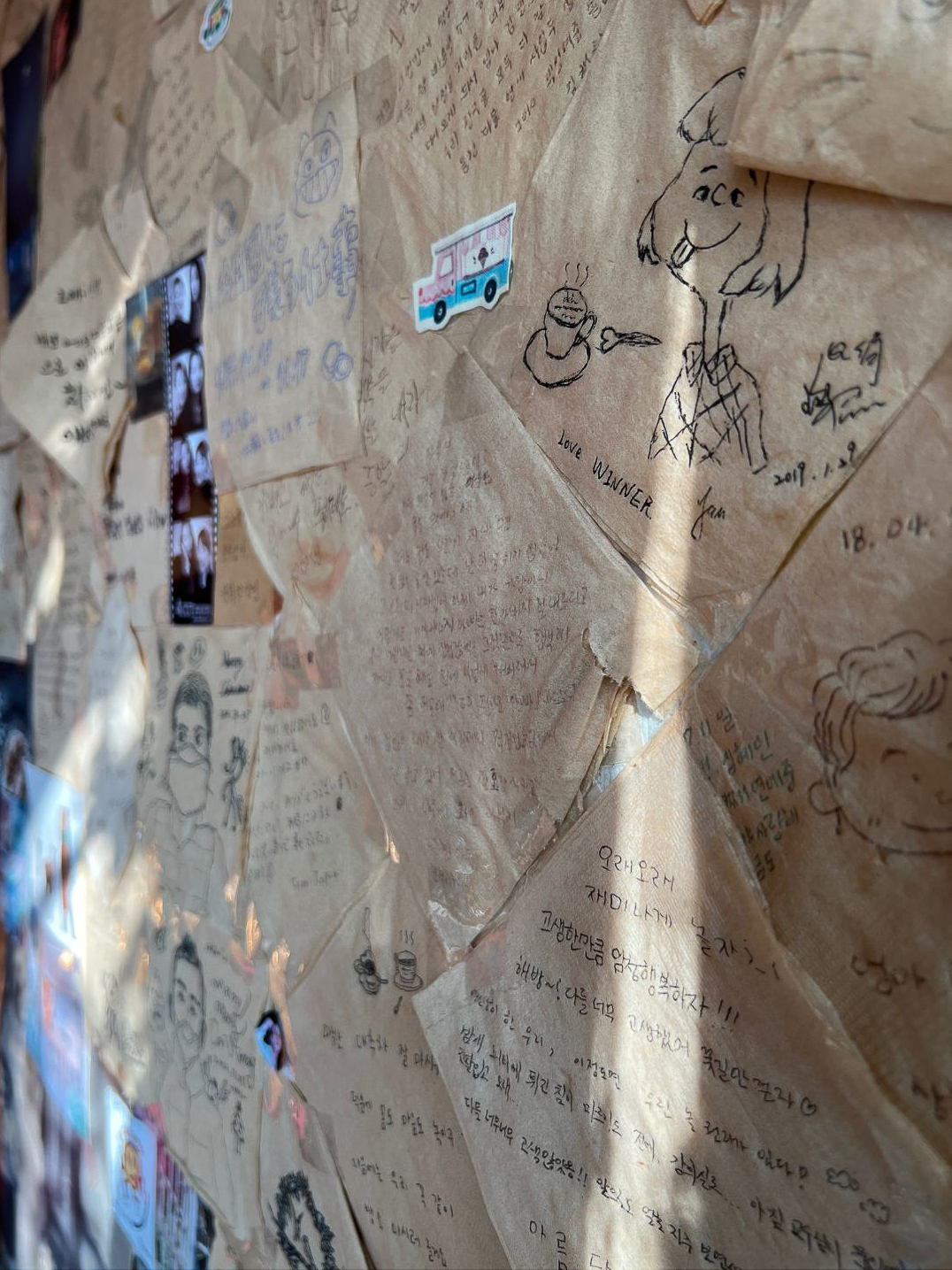 A drawing of Peppermint Patty and a cup of tea along the famous napkin wall inside Whitebirch Story Tea House in Seoul, South Korea