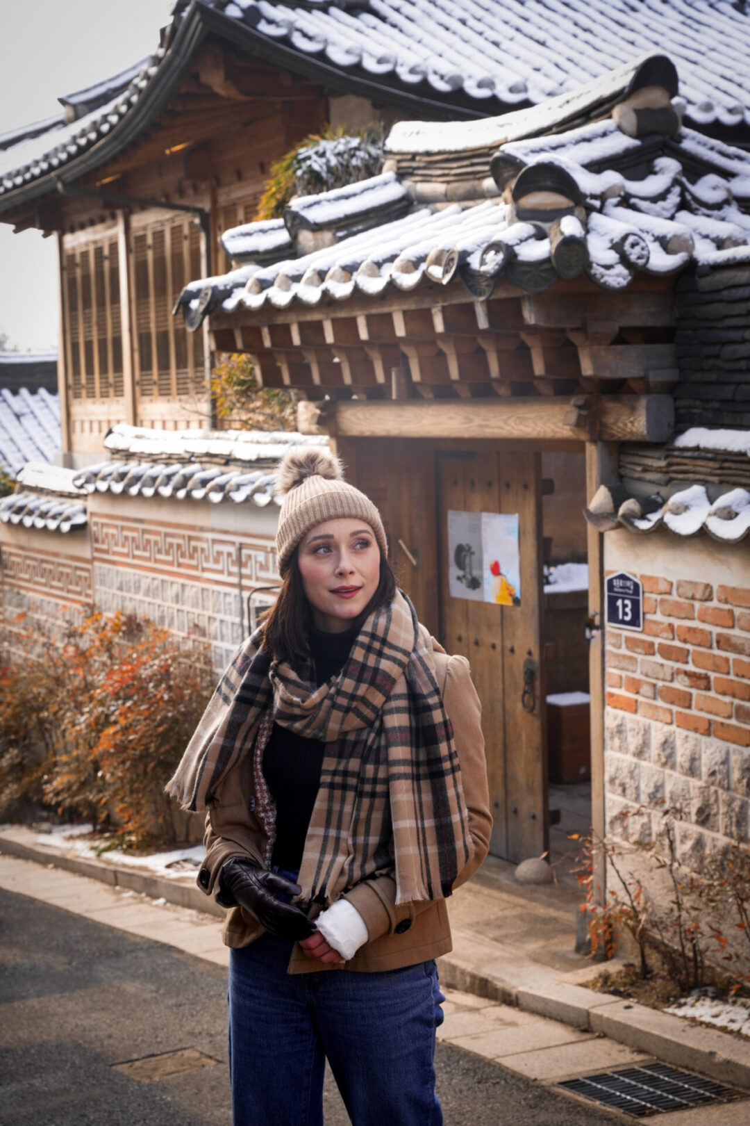 Travel Blogger Jordan Gassner walking in front of a traditional hanok house inside Bukchon Hanok Village in Seoul, South Korea
