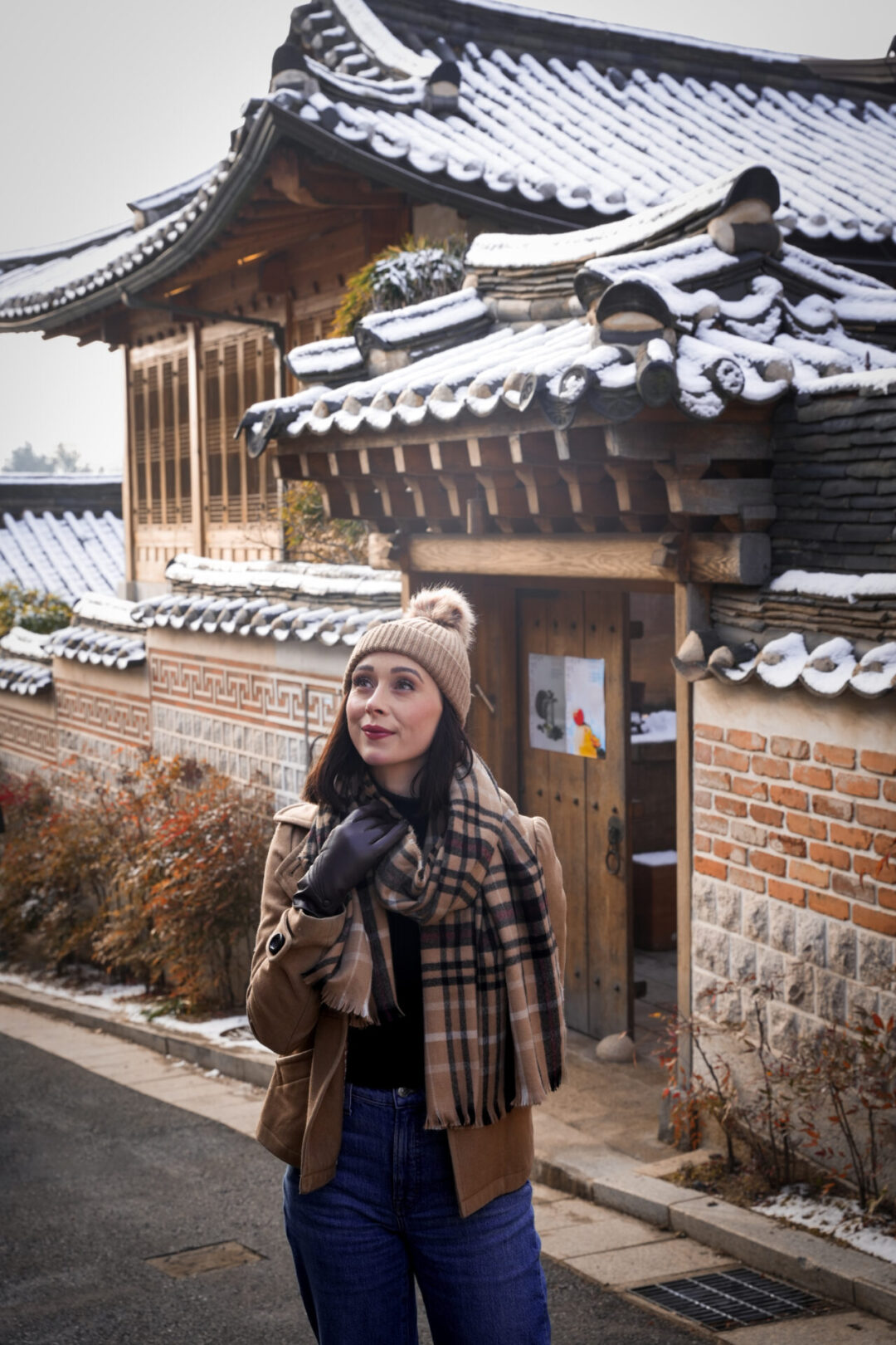 Travel Blogger Jordan Gassner standing in front of a traditional hanok house inside Bukchon Hanok Village in Seoul, South Korea