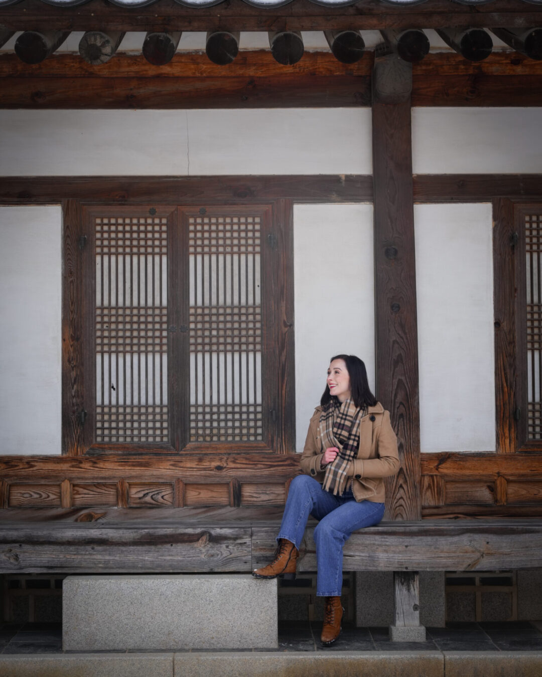 Travel Blogger Jordan Gassner smiling from the porch of Heungbokjeon Hall in Gyeongbokgung Palace in Seoul, South Korea