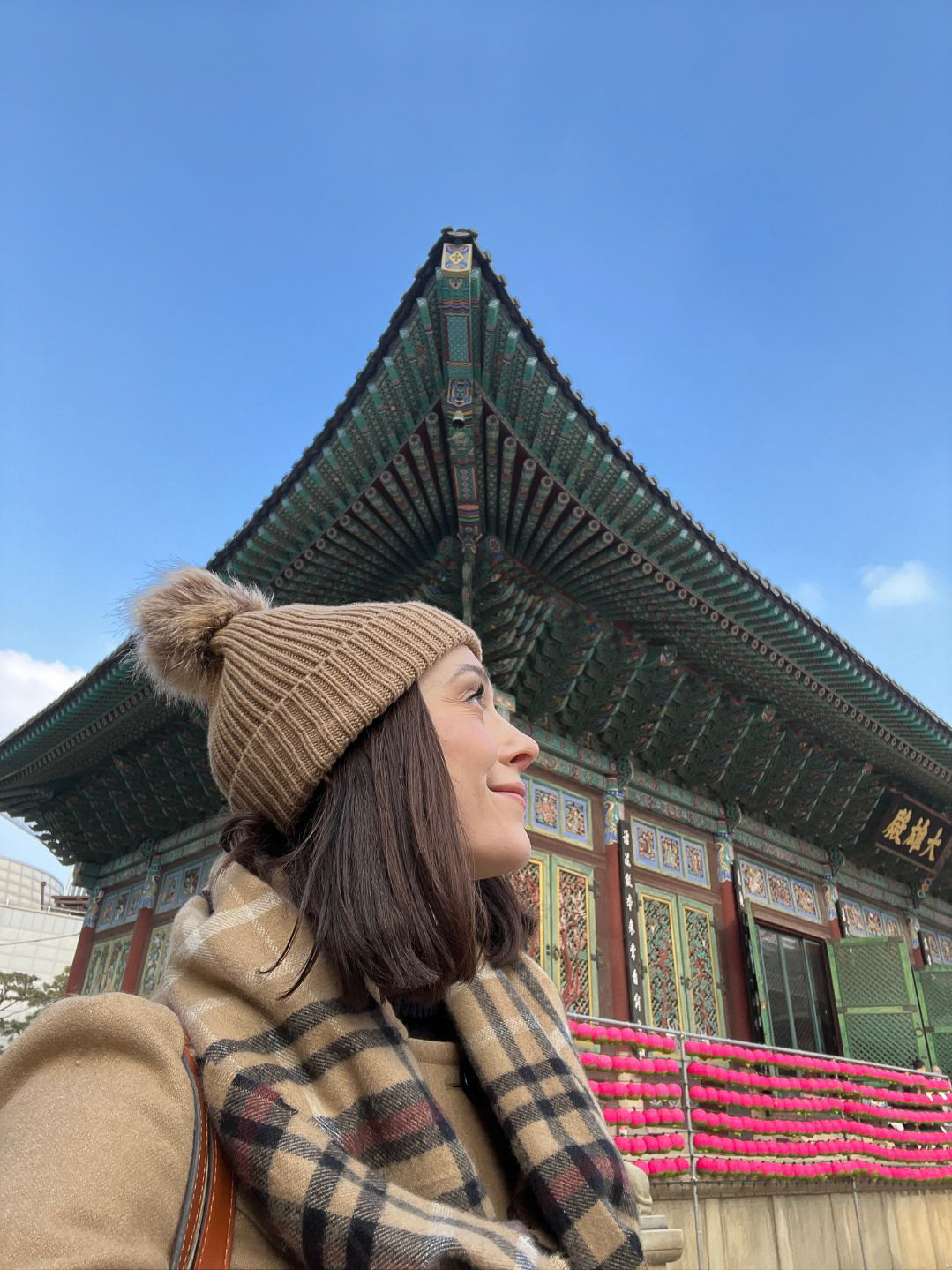 Travel Blogger Jordan Gassner looking up at the decorations of Jogyesa Temple on her layover in Seoul, South Korea