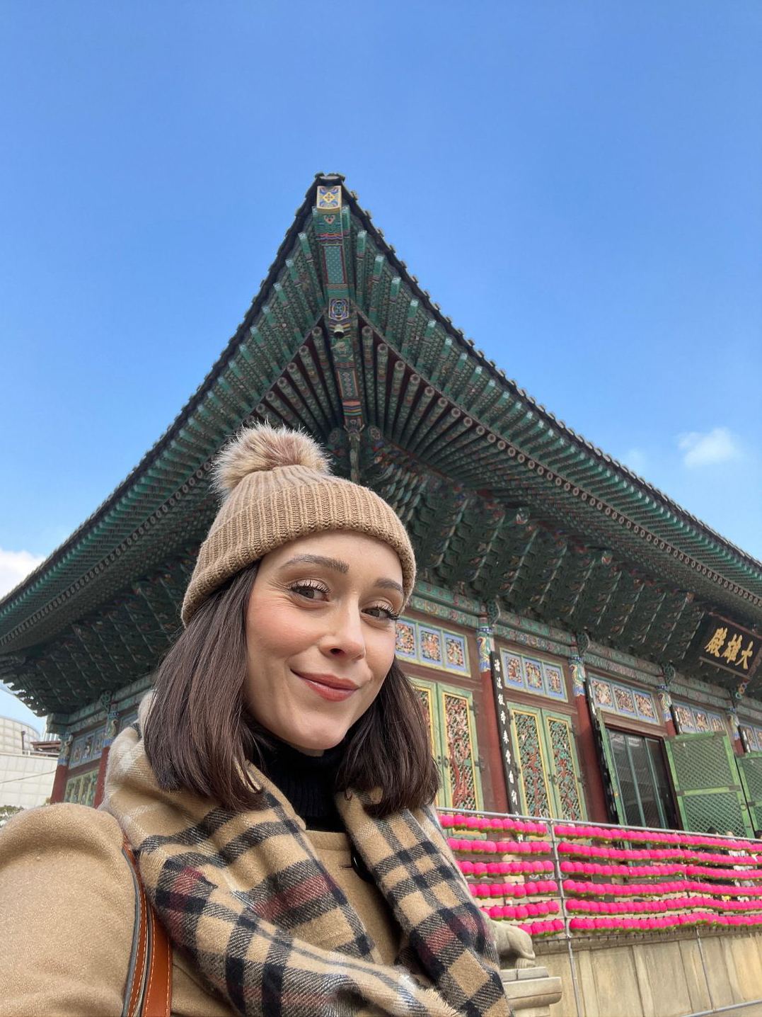Travel Blogger Jordan Gassner smiling while standing near Jogyesa Temple in Seoul, South Korea