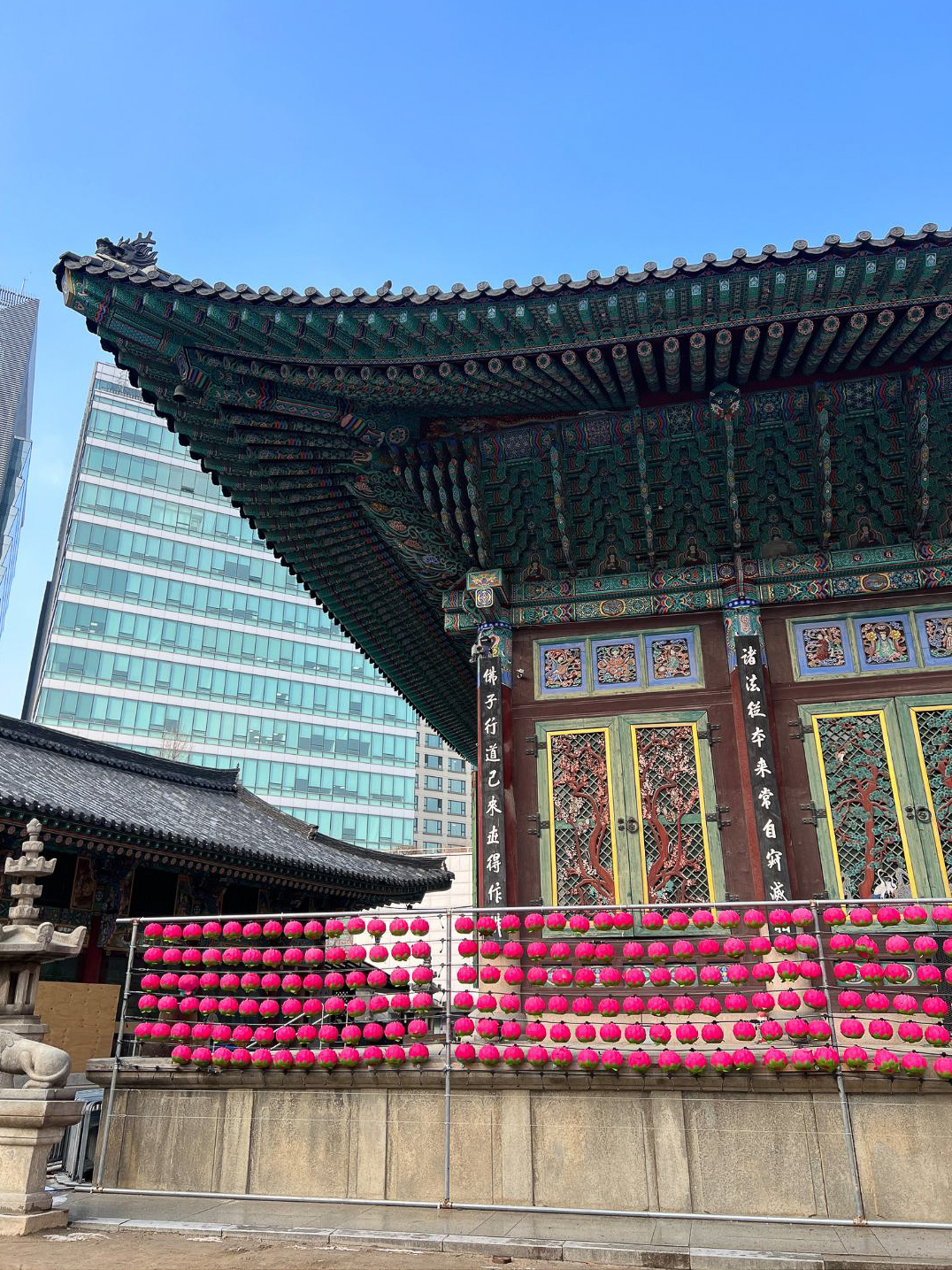 The traditional design of Jogyesa Temple with view of modern skyscrapers just behind in Seoul, South Korea
