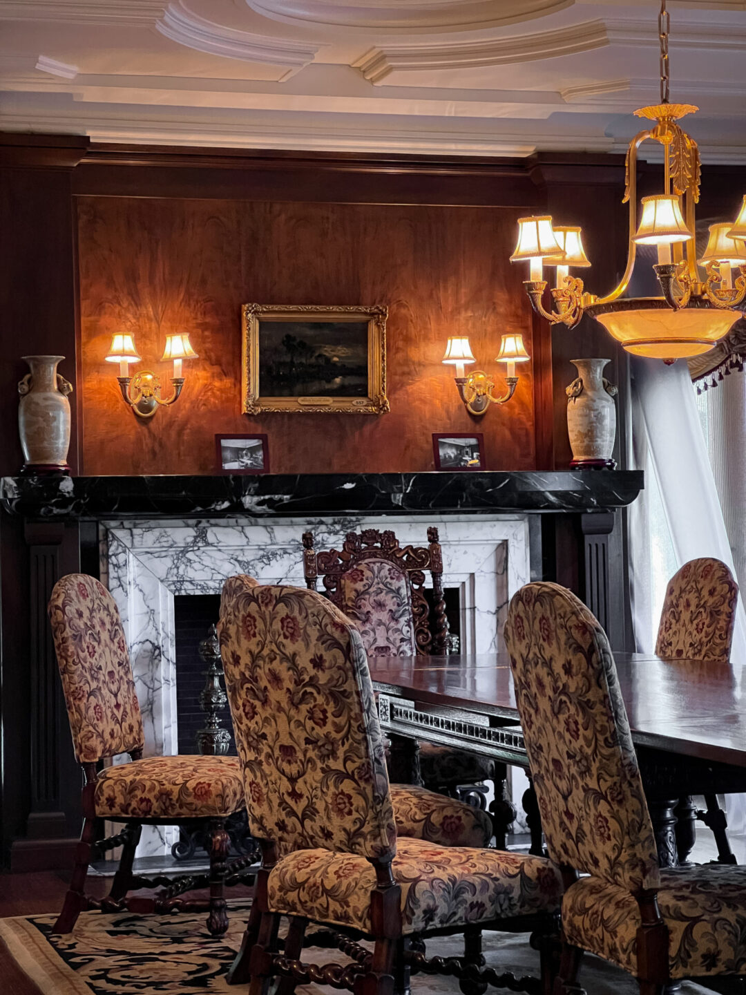 Home Tours in Los Angeles: The opulent dining room furniture and marble fireplace inside the Wrigley Mansion in Pasadena, California