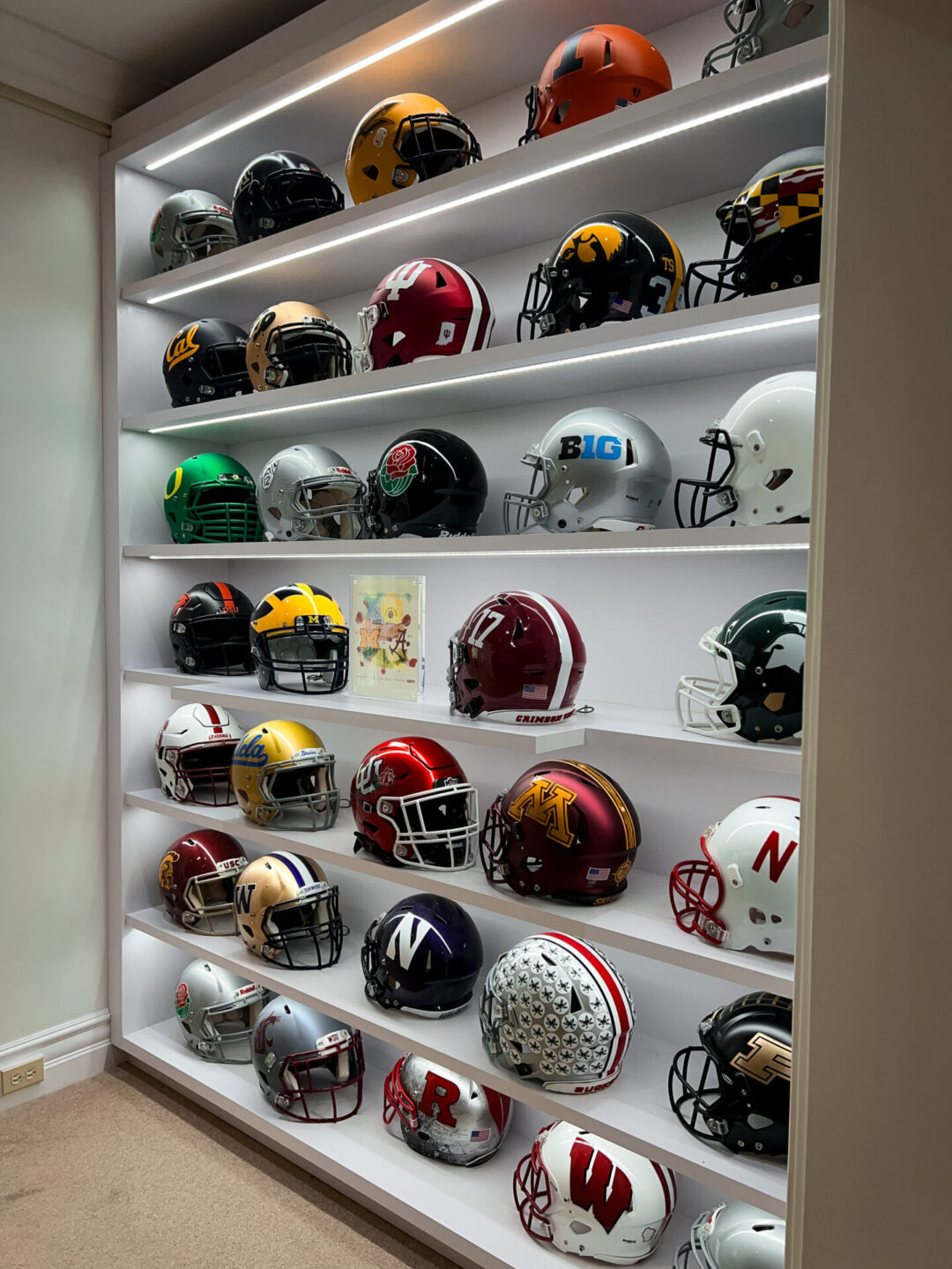 Home Tours in Los Angeles: A collection of college football helmets on display inside The Wrigley Mansion in Pasadena, California